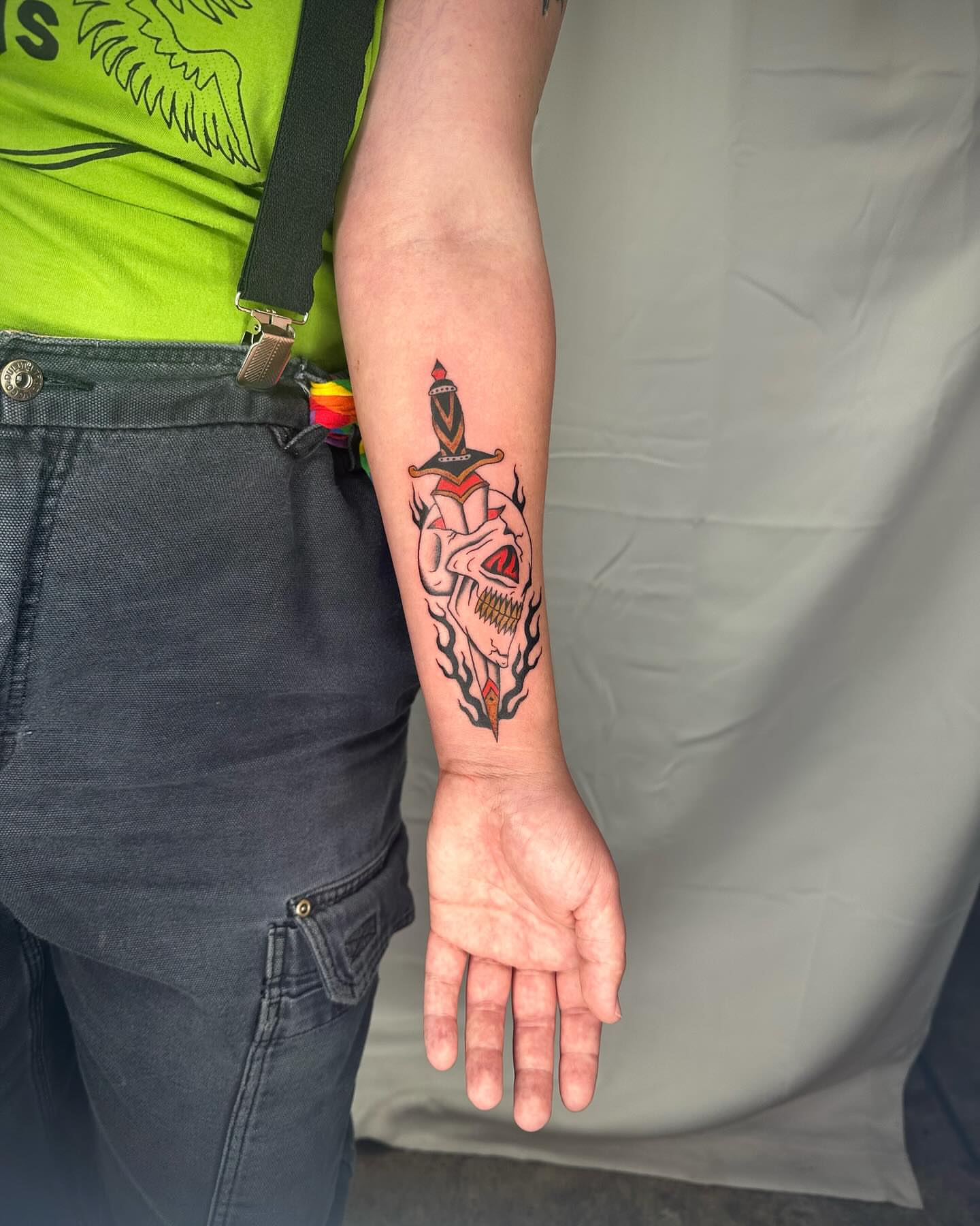 Skull with dagger American traditional tattoo on the forearm by rory