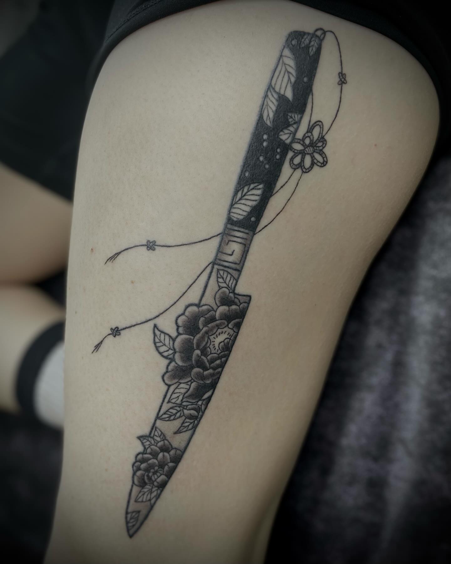 Sword and floral ornamental tattoo on the thigh by Shelbie, Salt Lake City, Utah