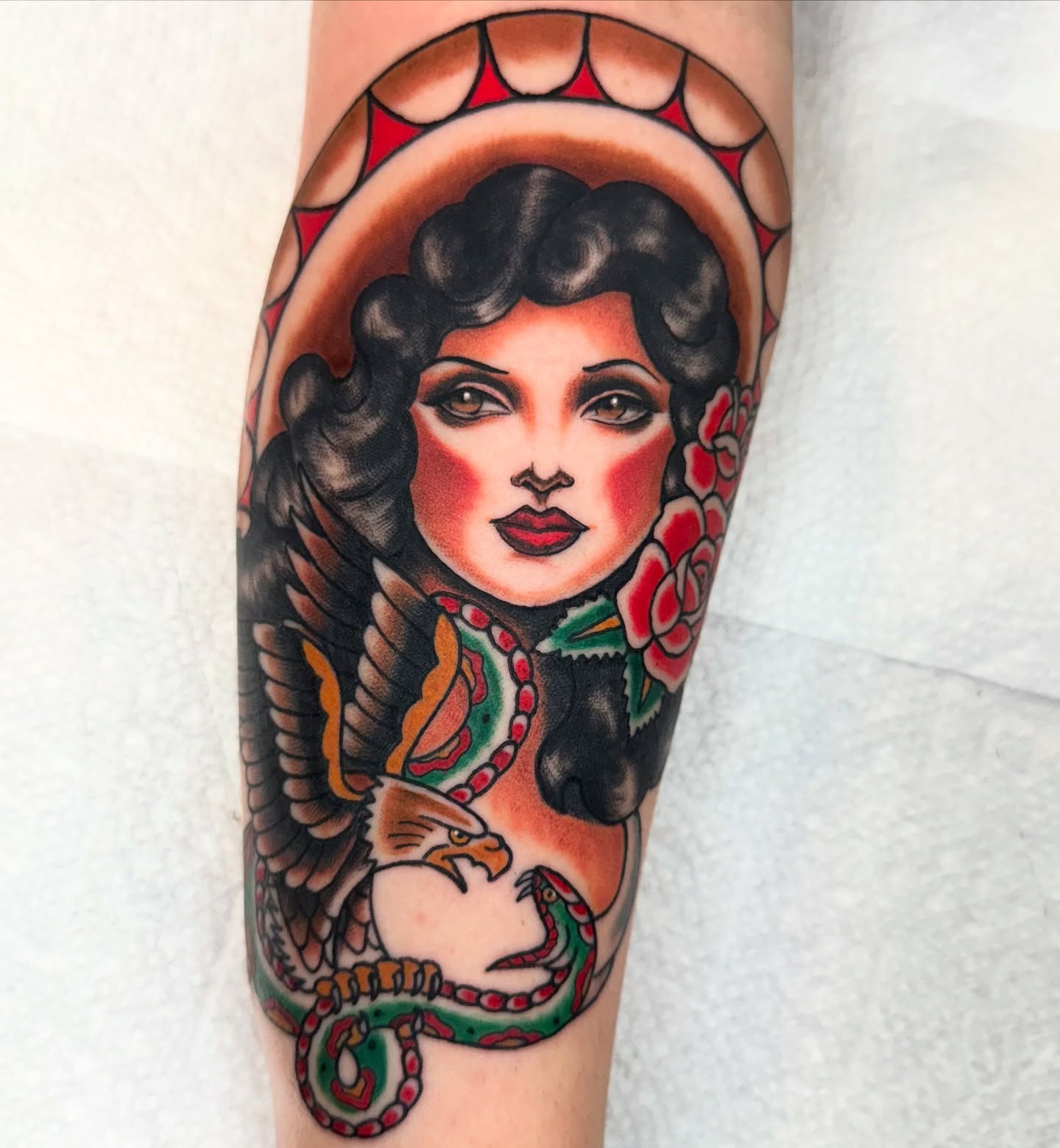 Woman with snake American traditional tattoo on the forearm by Lisa Del Toro