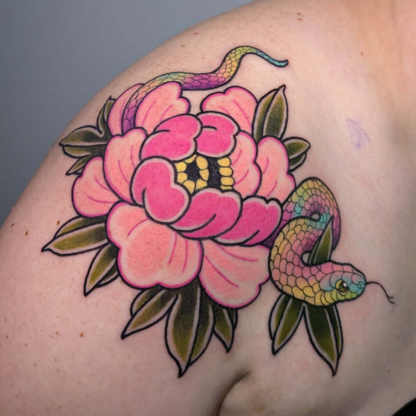 Snake and peony American traditional tattoo on the shoulder by Ellie