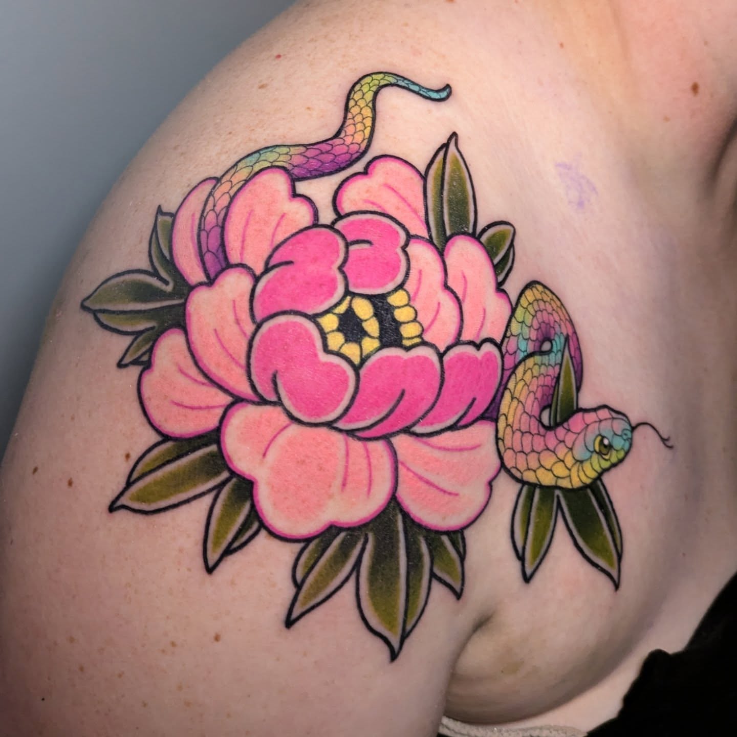 Snake and peony American traditional tattoo on the shoulder by Ellie