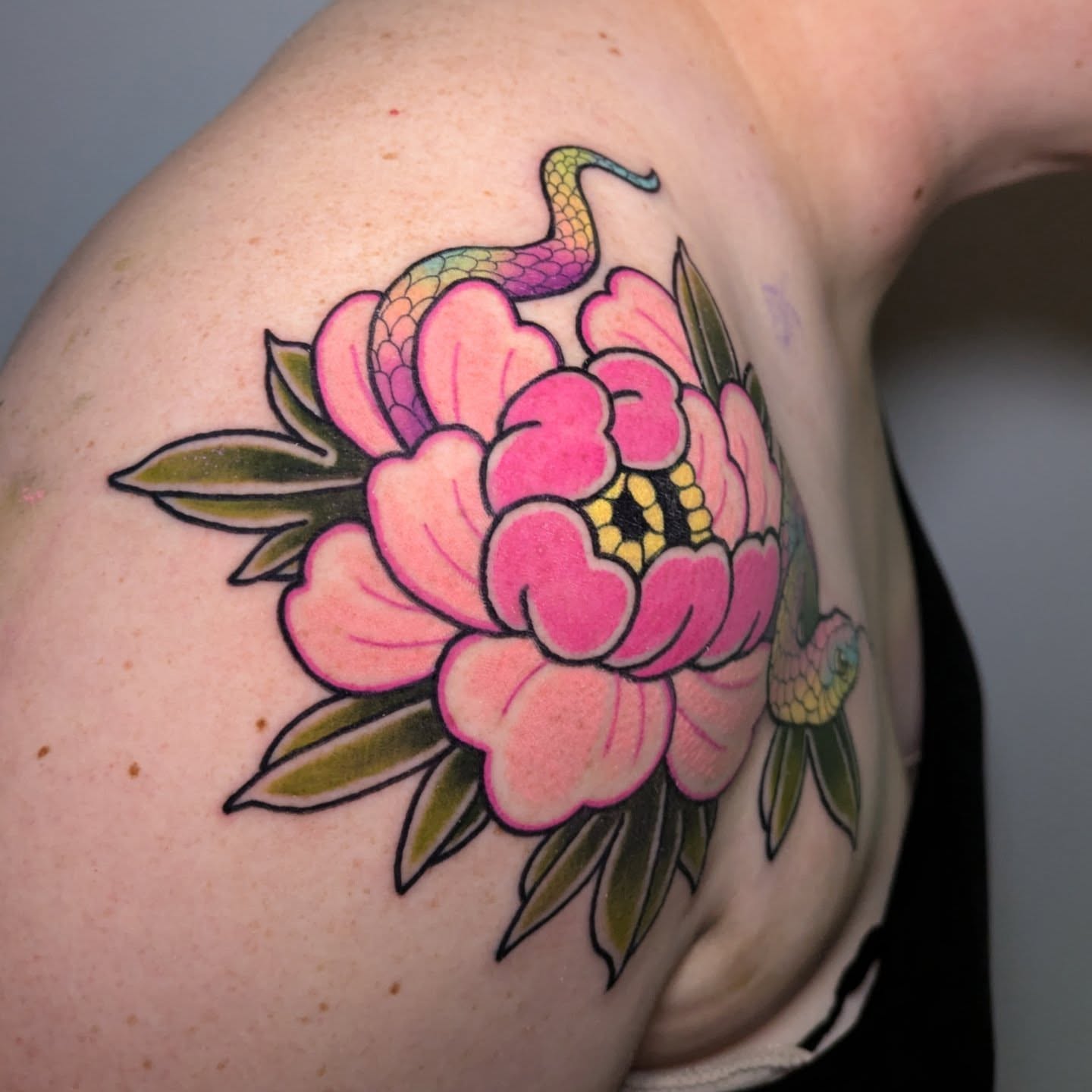 Snake and peony American traditional tattoo on the shoulder by Ellie