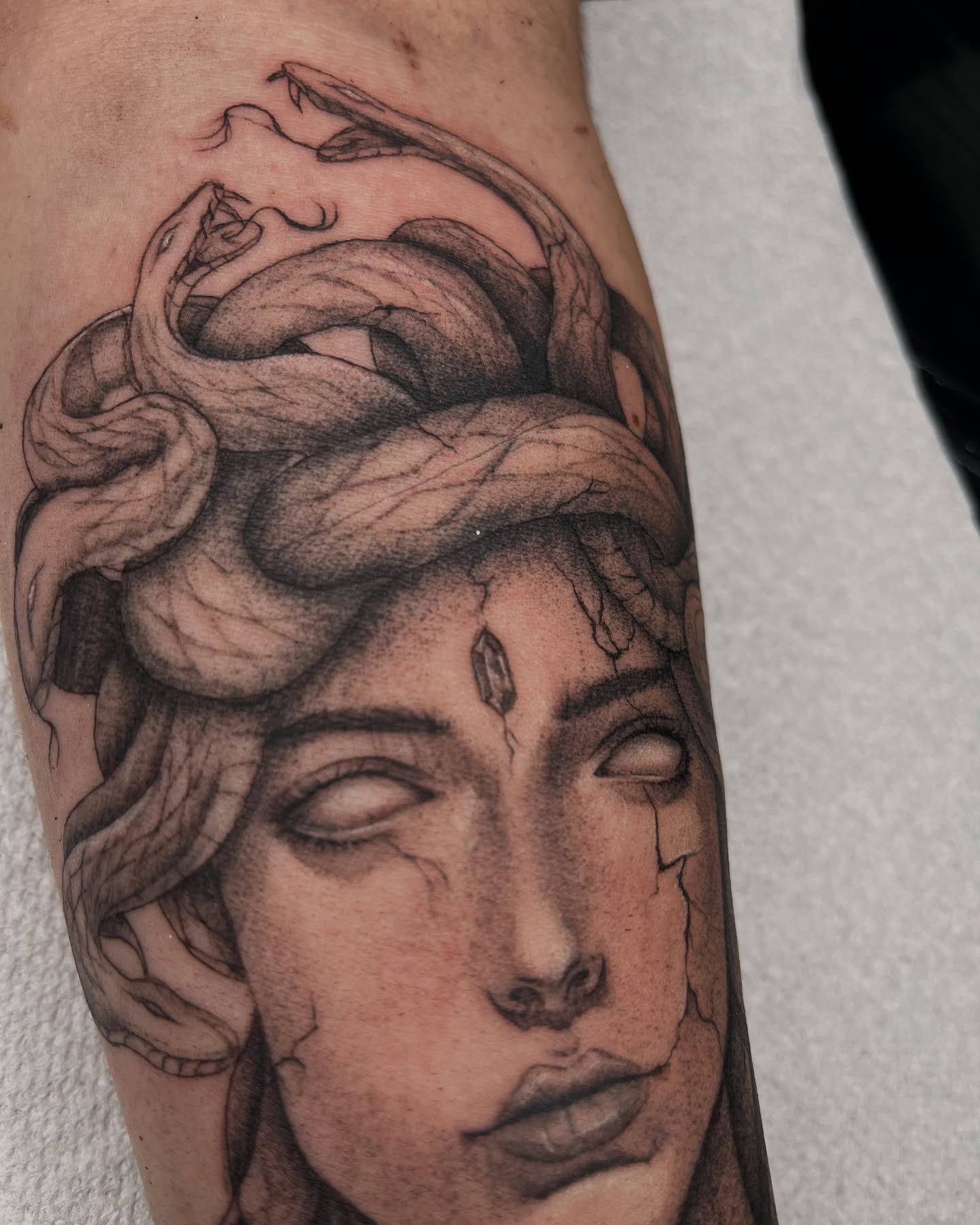 Woman with snakes realism tattoo on the forearm by Dotwork