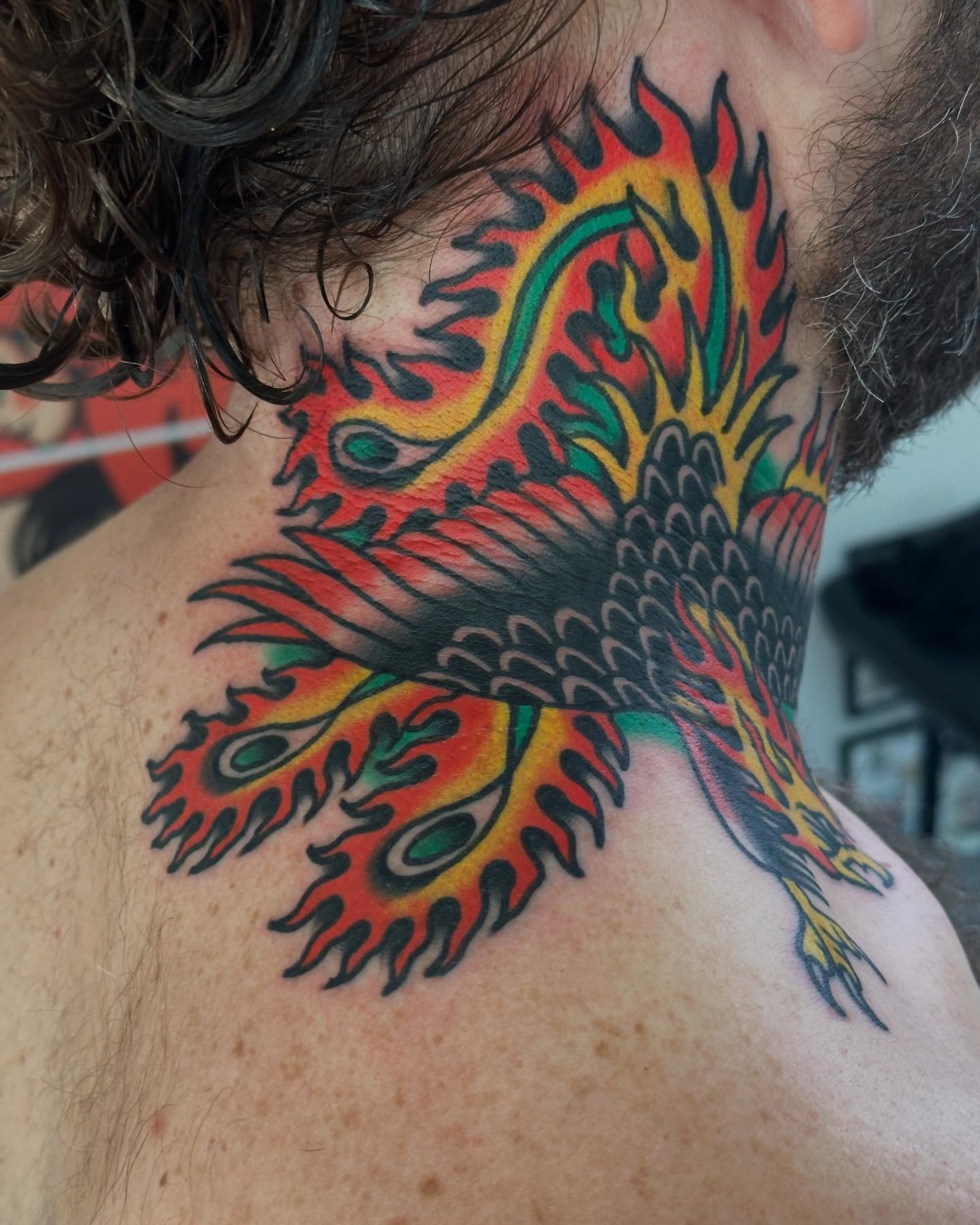Peacock American traditional tattoo on the neck by Steve Pearson