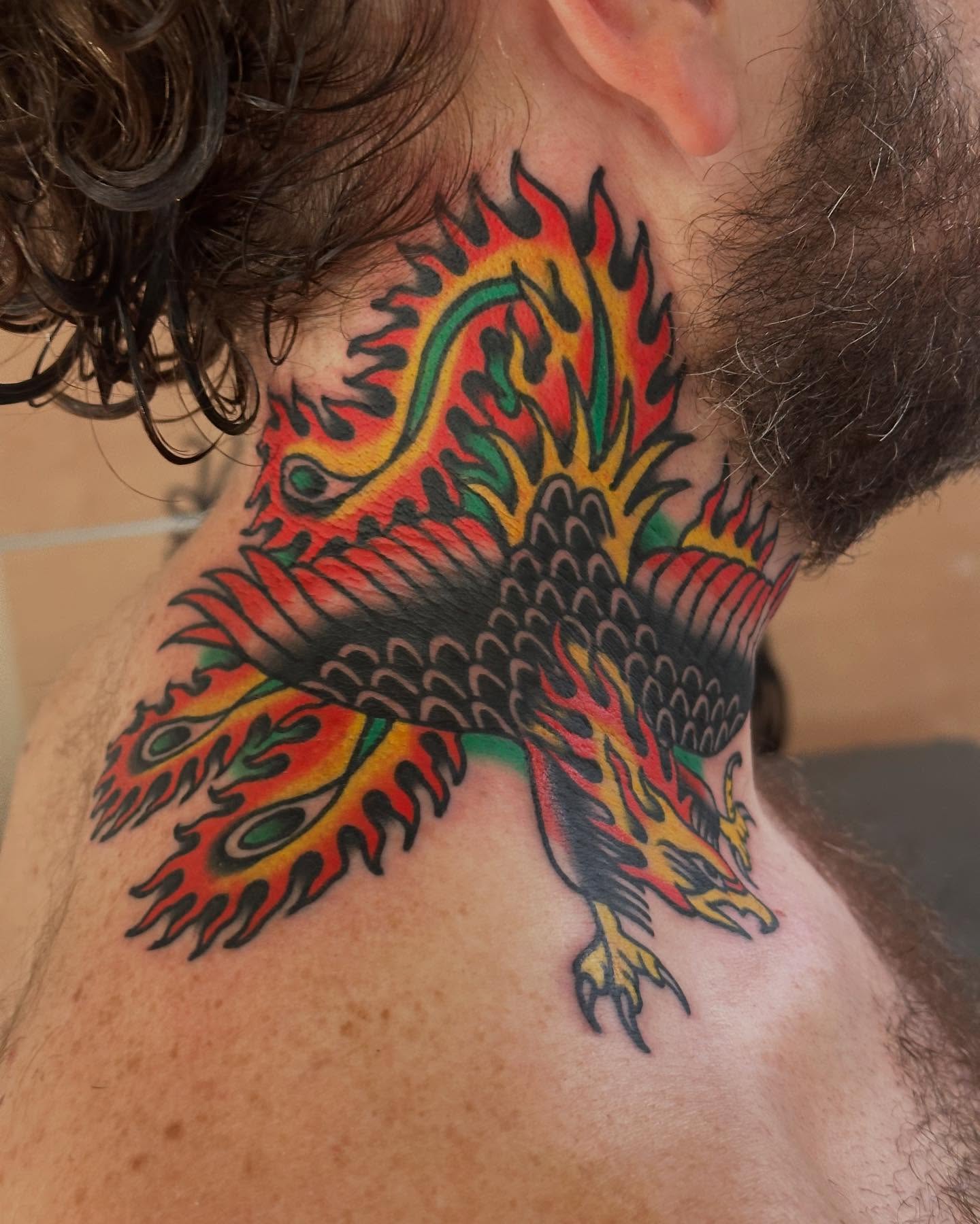 Flaming phoenix American traditional tattoo on the neck by Steve Pearson