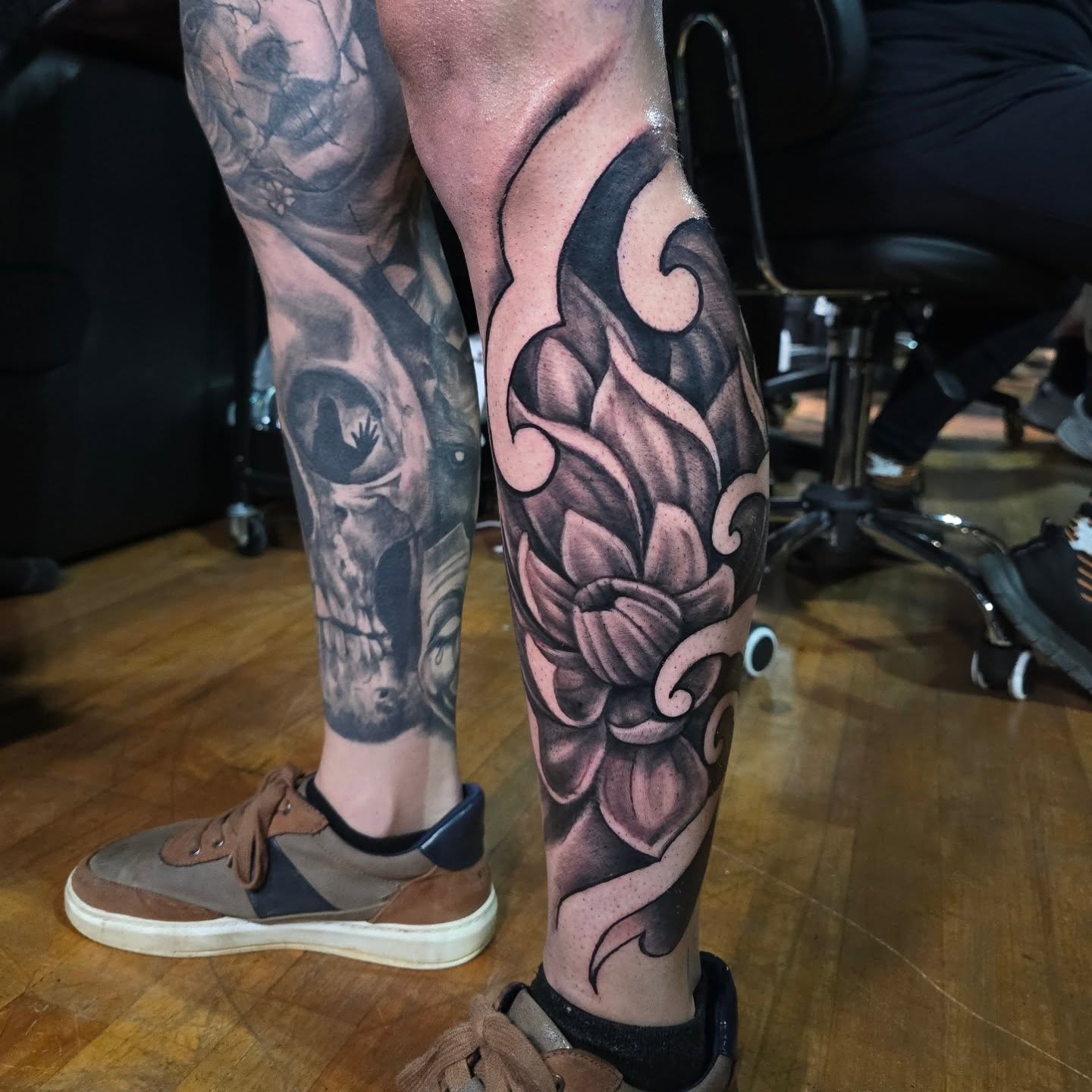 Floral design realism tattoo on the calf by Cody Lambert