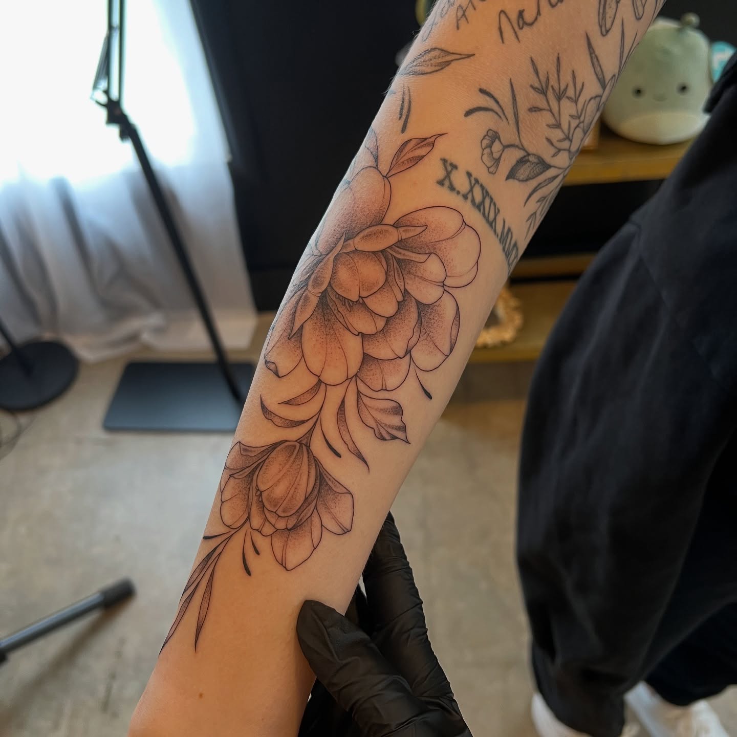 Floral bouquet black and grey tattoo on the forearm by Dom