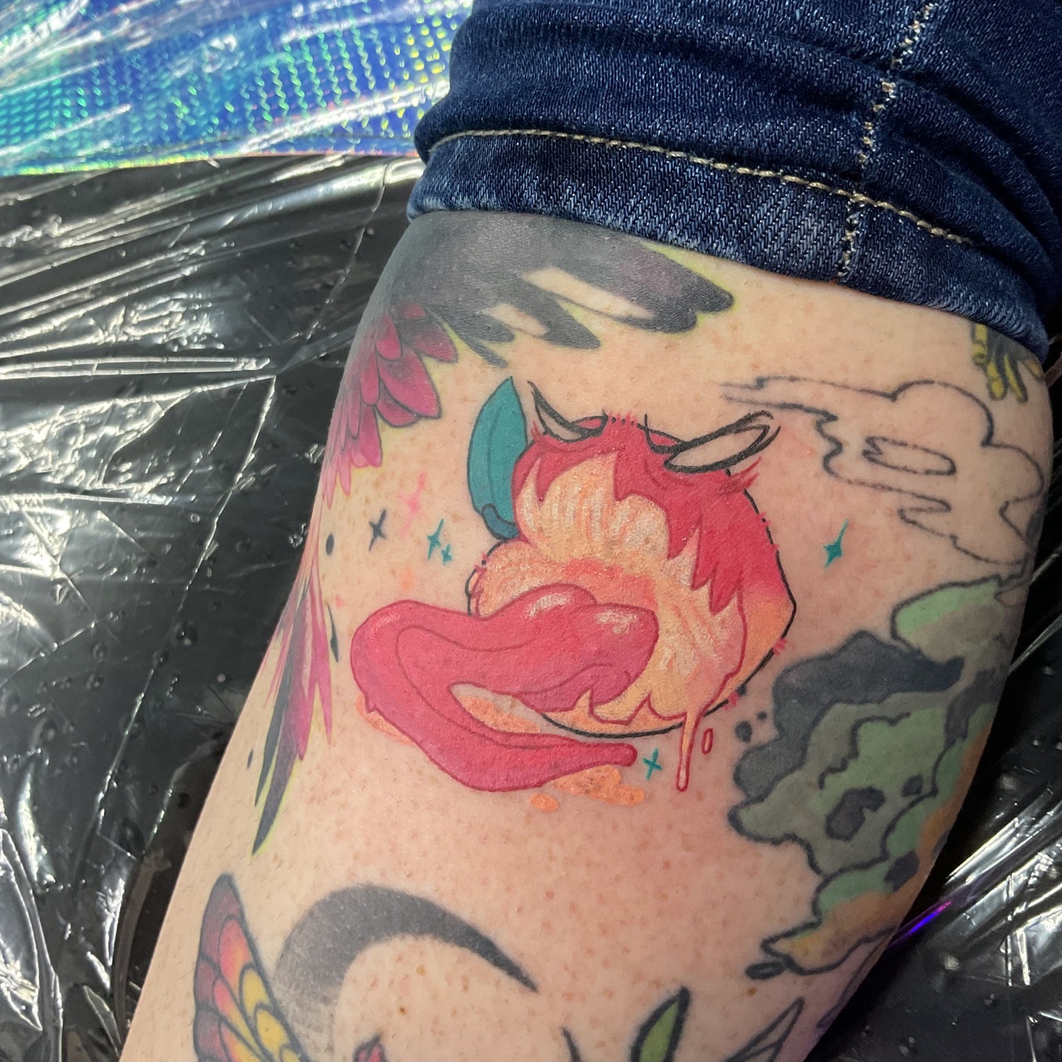 Flame creature anime tattoo on the thigh by Iram Withencroft