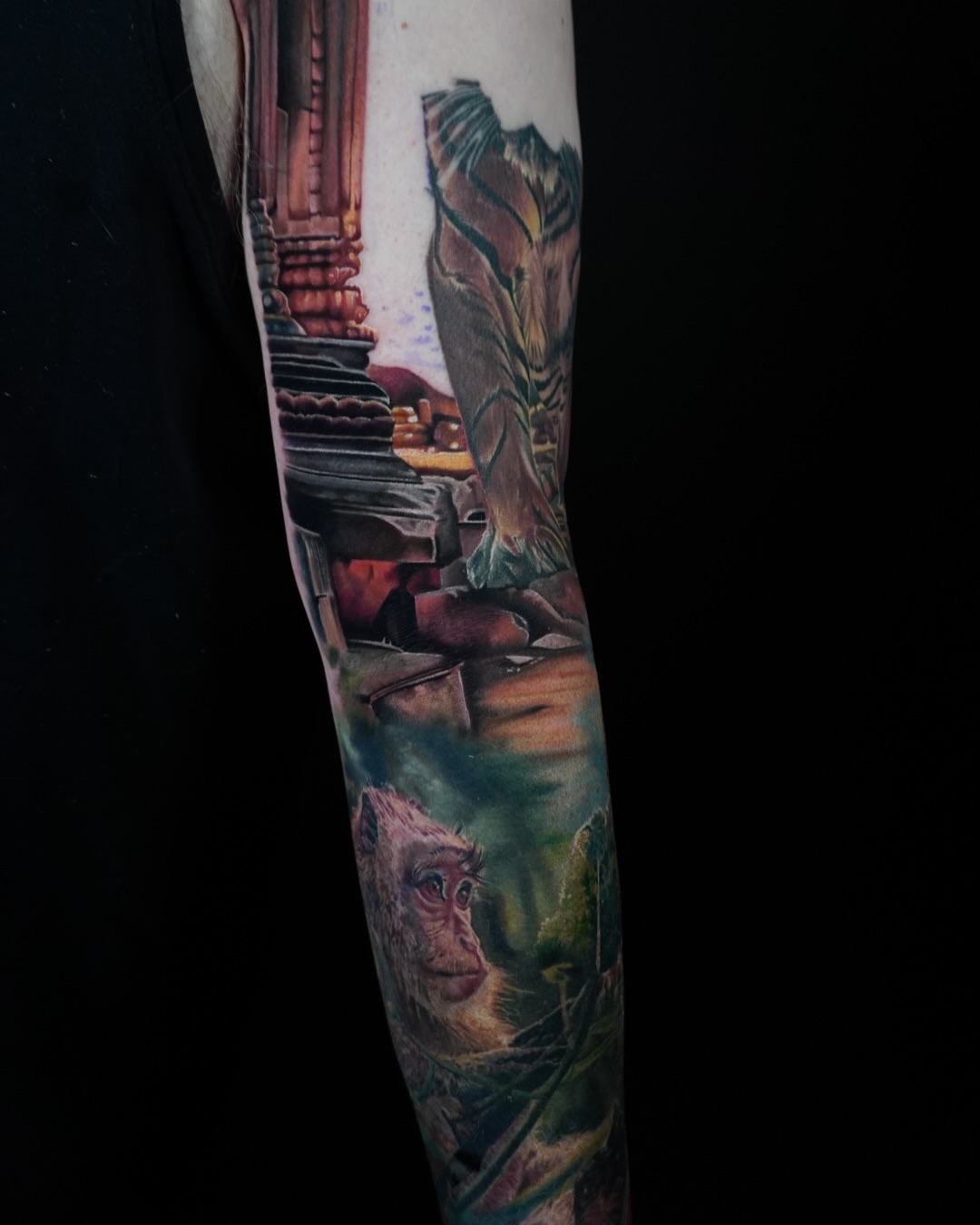 Ancient ruins and monkey realism tattoo on the forearm by Justin Shelpman