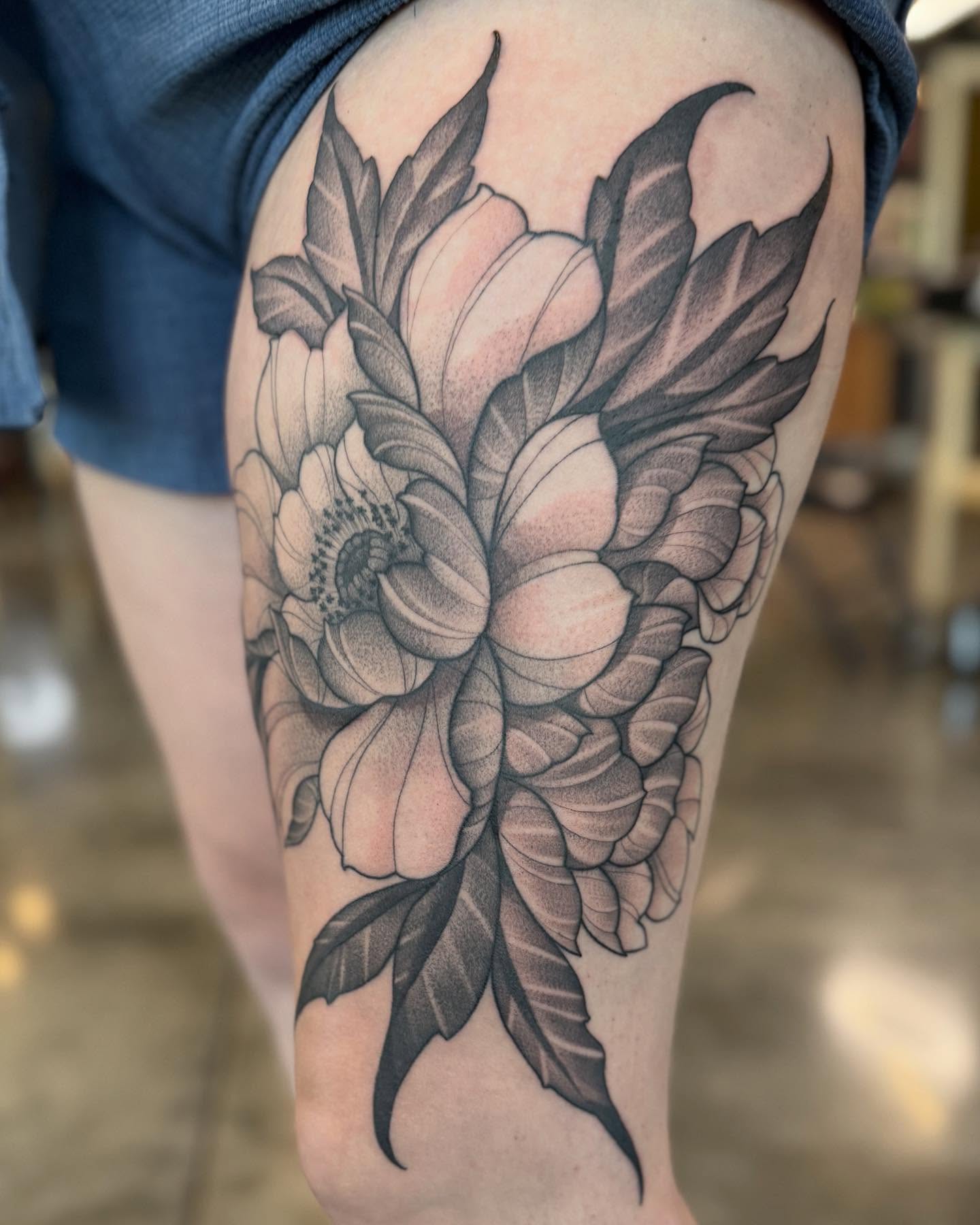 Flower black and grey tattoo on the thigh by Will Campbell