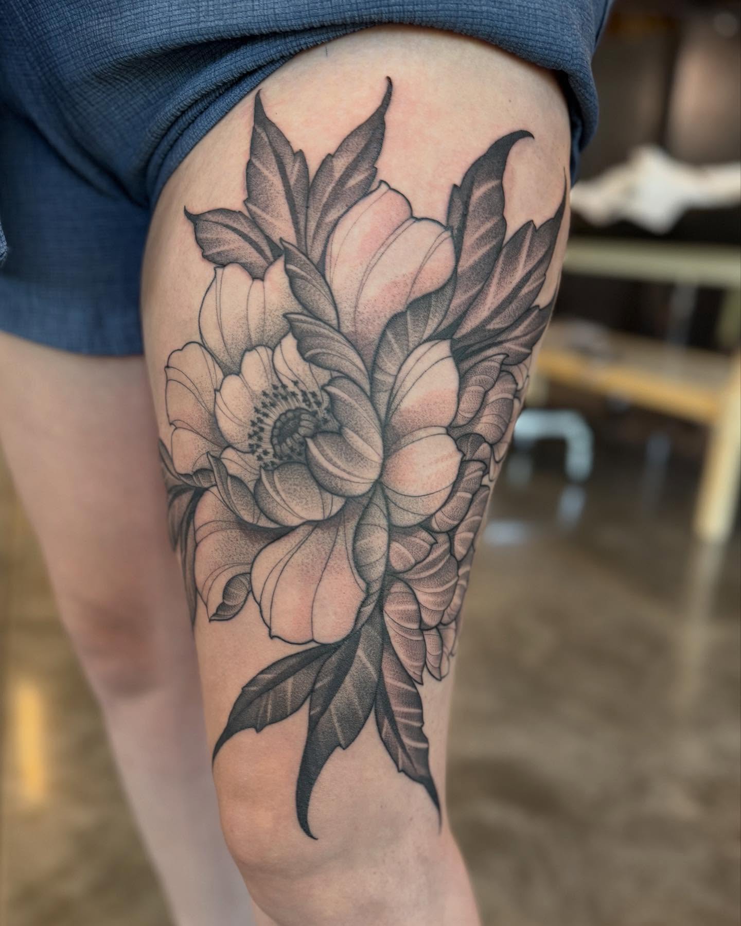 Flower dotwork tattoo on the thigh by Will Campbell