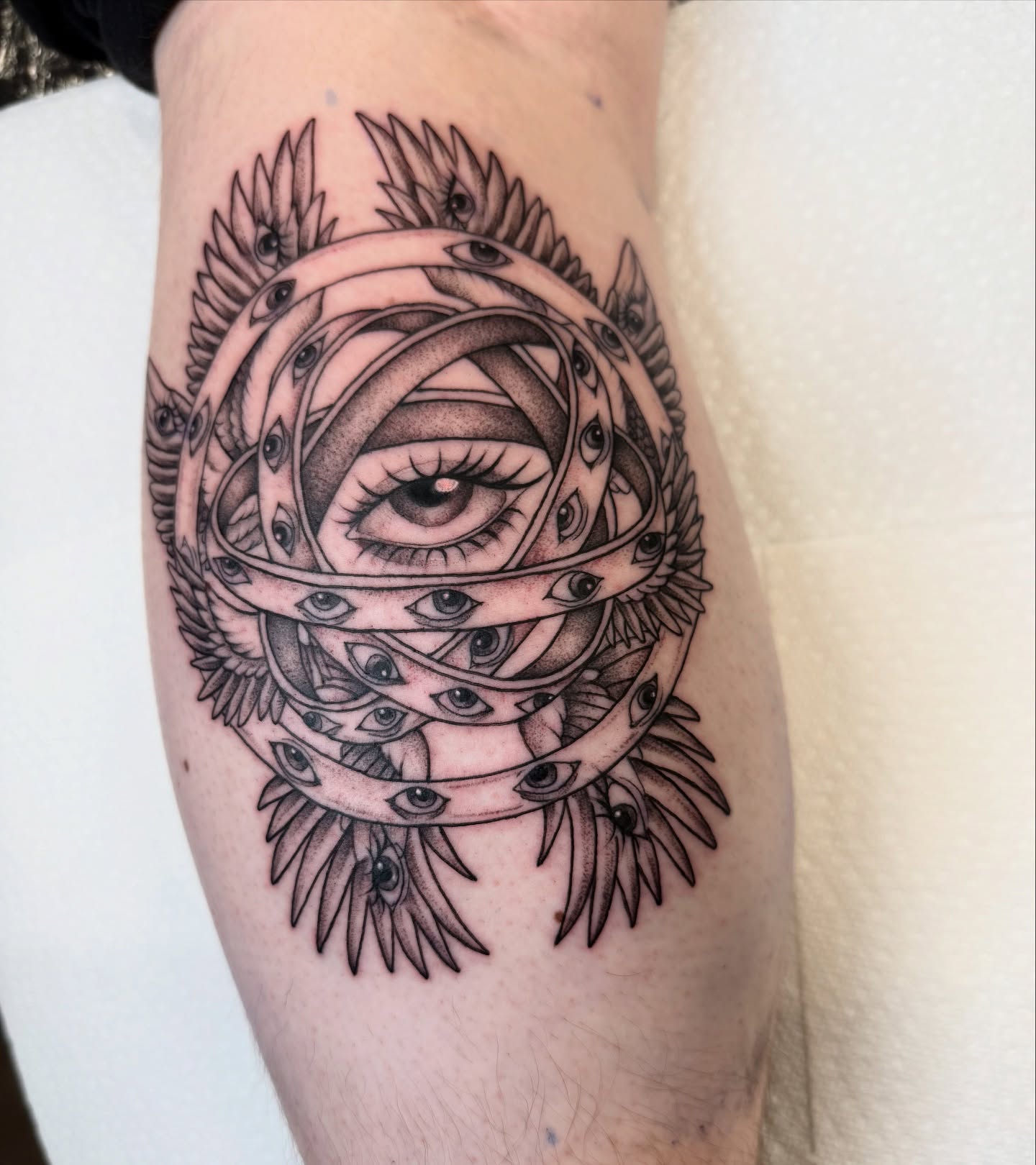 Eye and wings geometric tattoo on the forearm by dinah