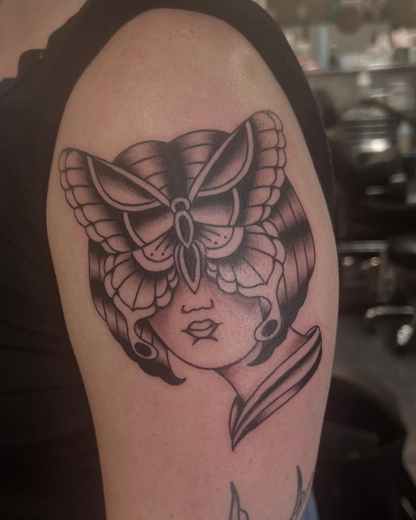 Woman with butterfly wings geometric tattoo on the shoulder by Erika Donn, Portland, Oregon