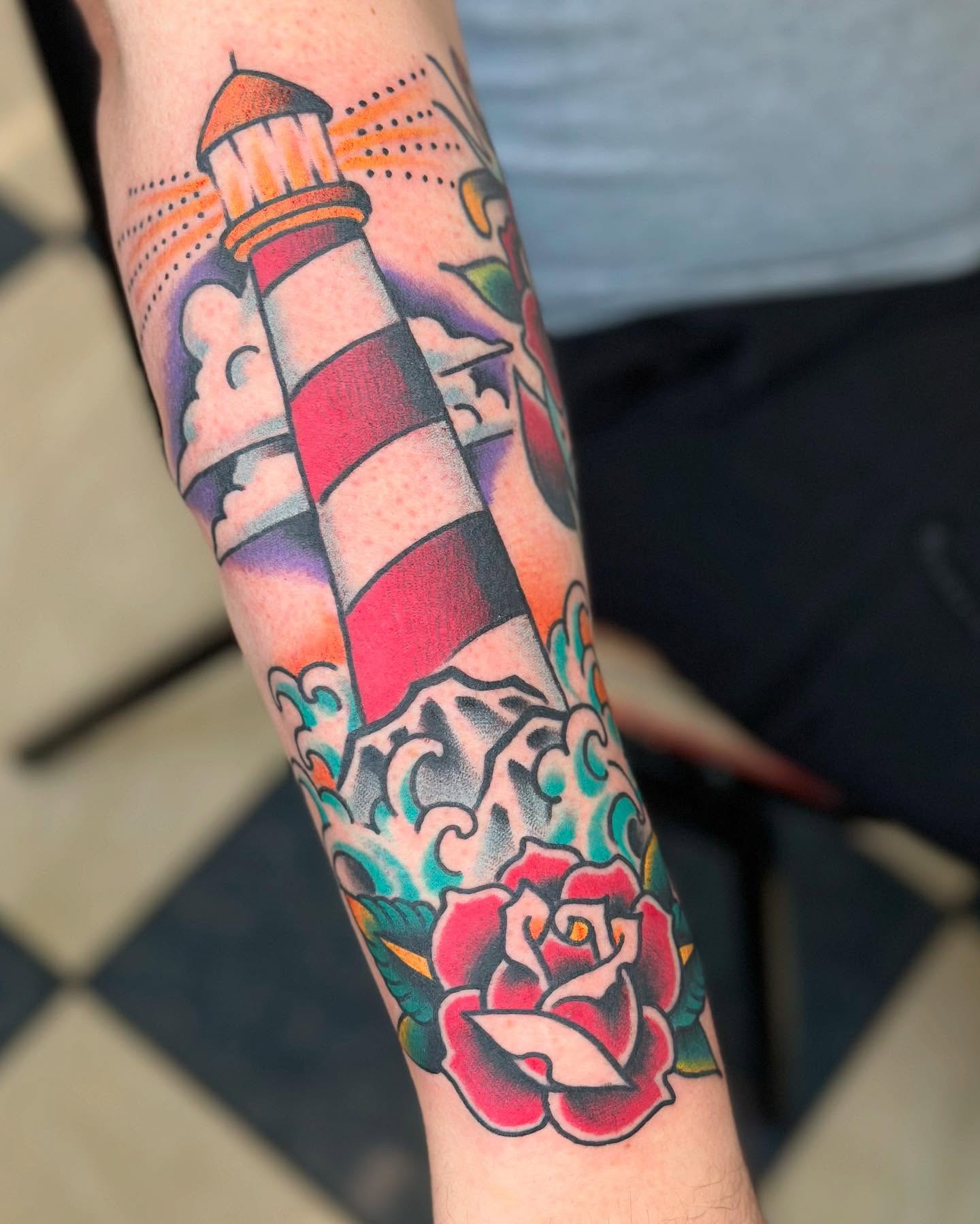 Lighthouse and rose American traditional tattoo on the forearm by David Steed, Dallas, Texas