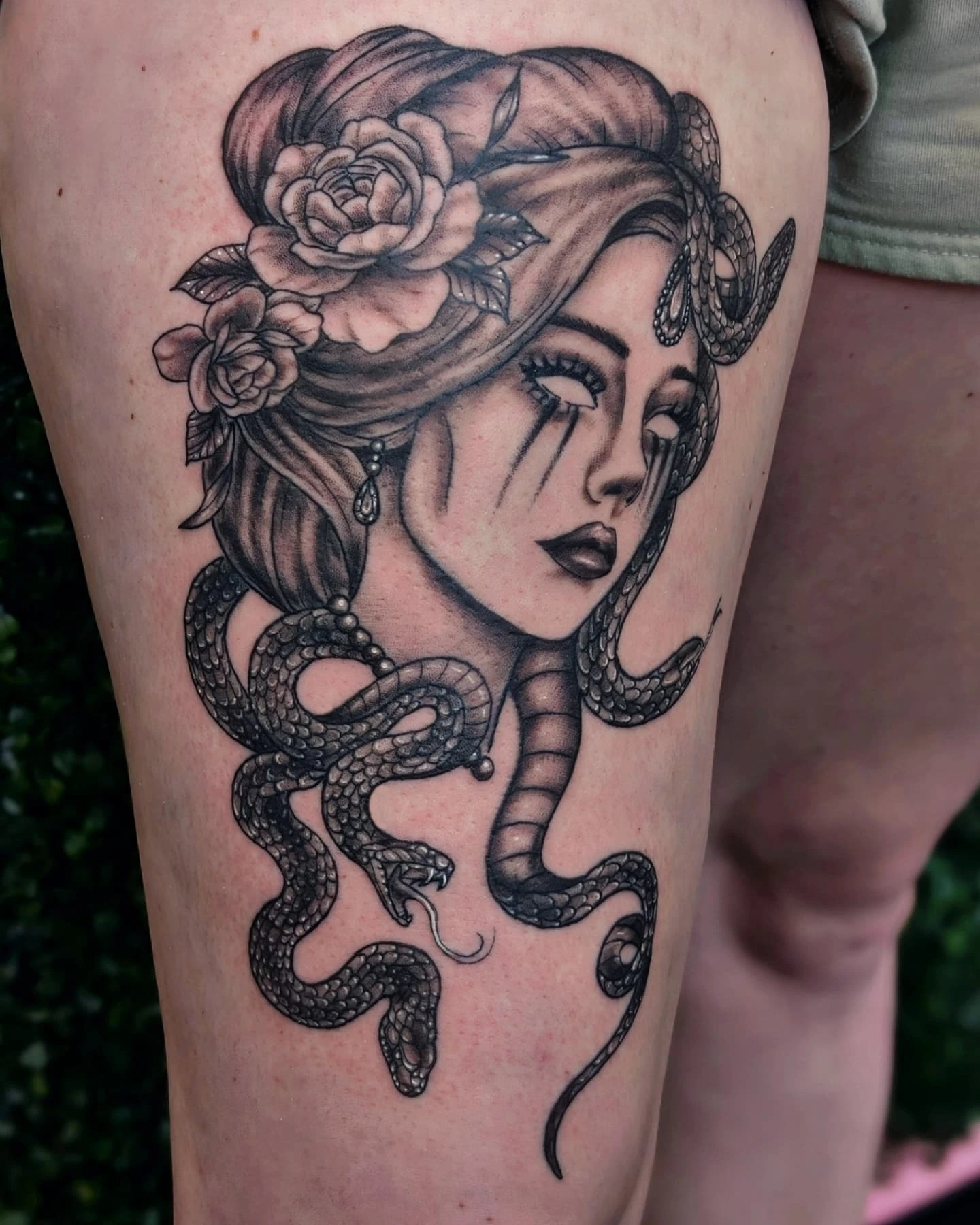 Woman with snakes realism tattoo on the thigh by Marlayna Connelly