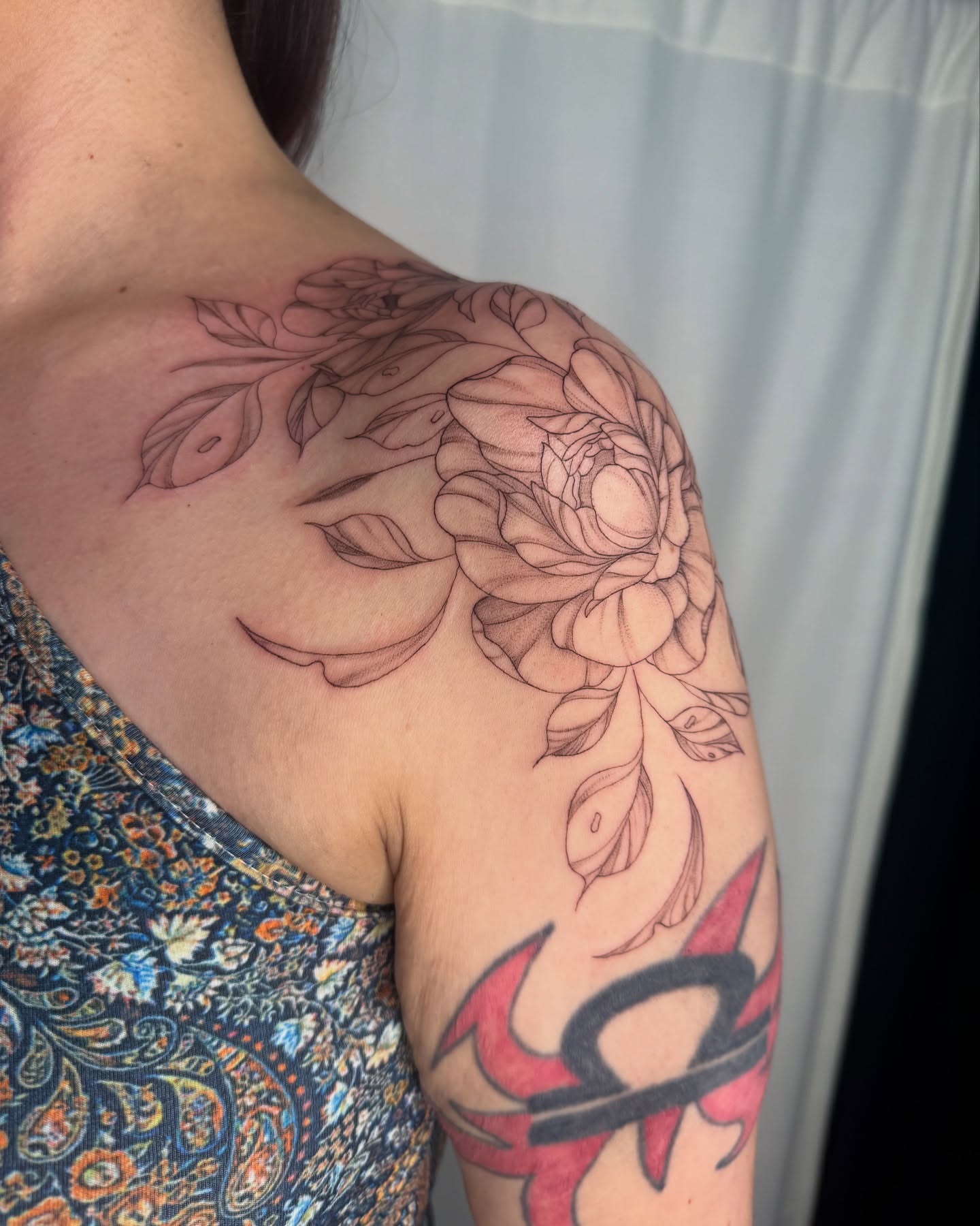 Floral design black and grey tattoo on the shoulder by elena