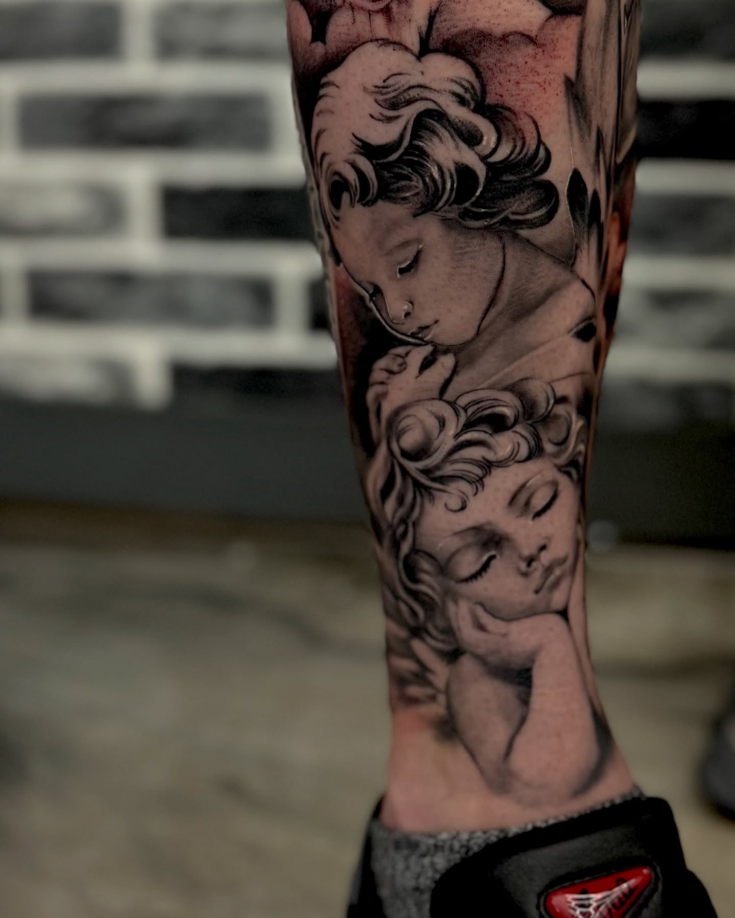 Sleeping cherubs American traditional tattoo on the forearm by Mitsuko Ching