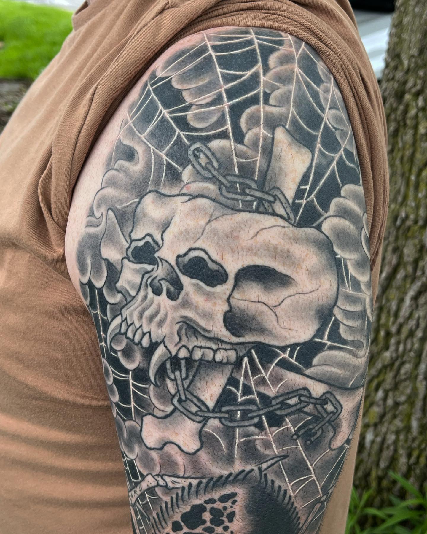 Skull and chains realism tattoo on the upper arm by TYP 419, Toledo, Ohio