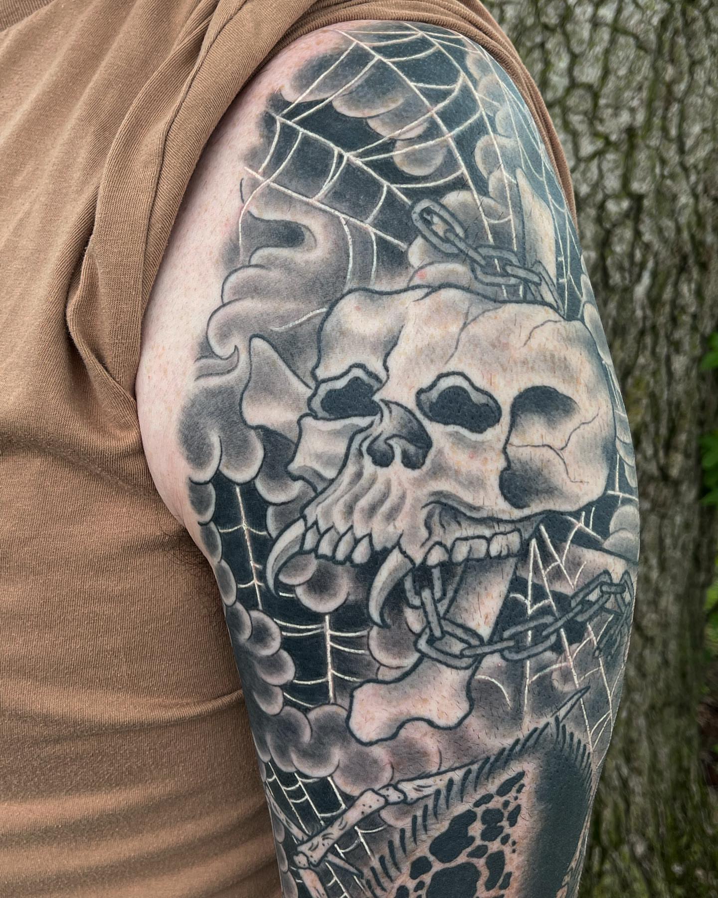 Skull realism tattoo on the upper arm by TYP 419, Toledo, Ohio