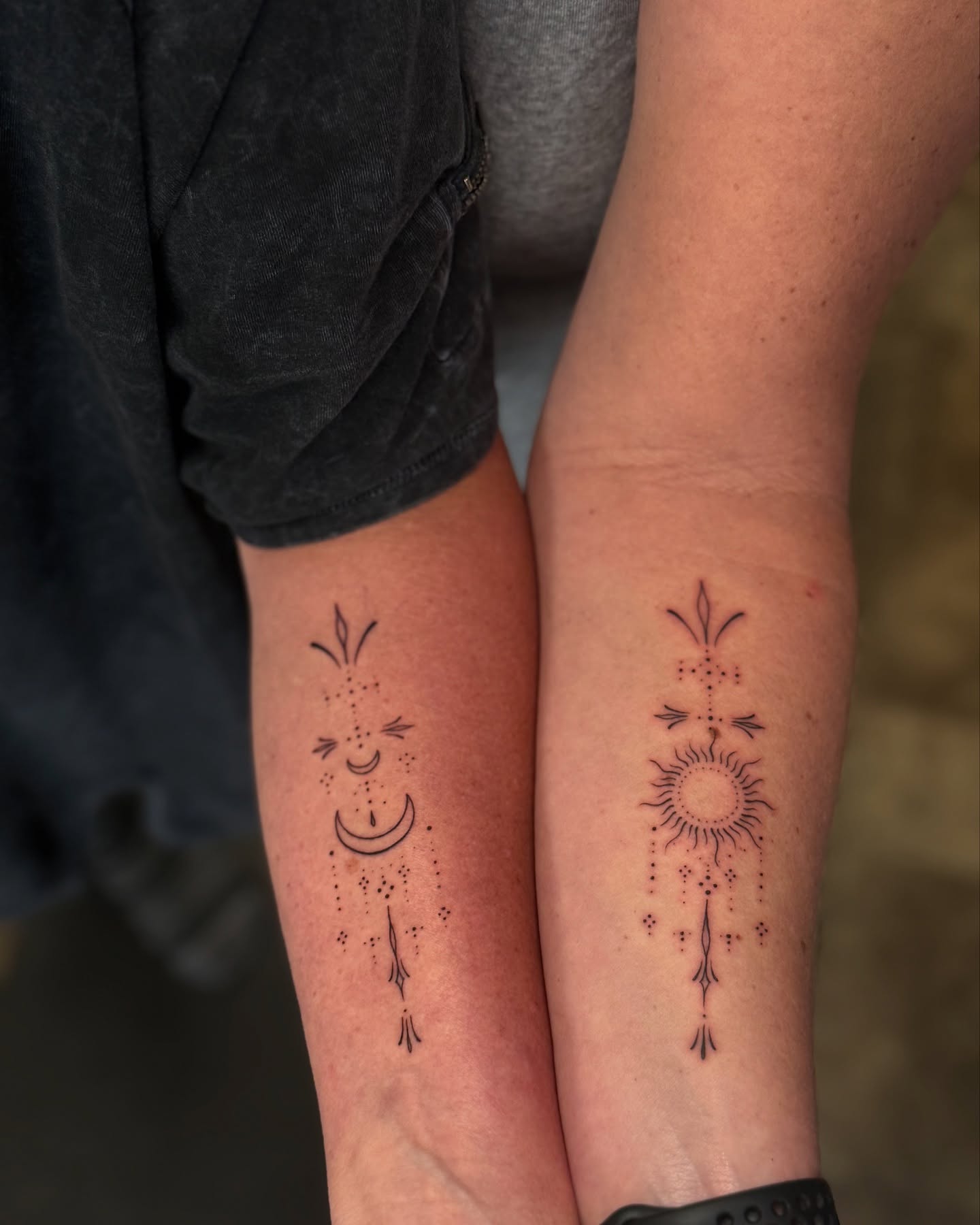 Sun and moon dotwork tattoo on the forearm by Loren Elbert