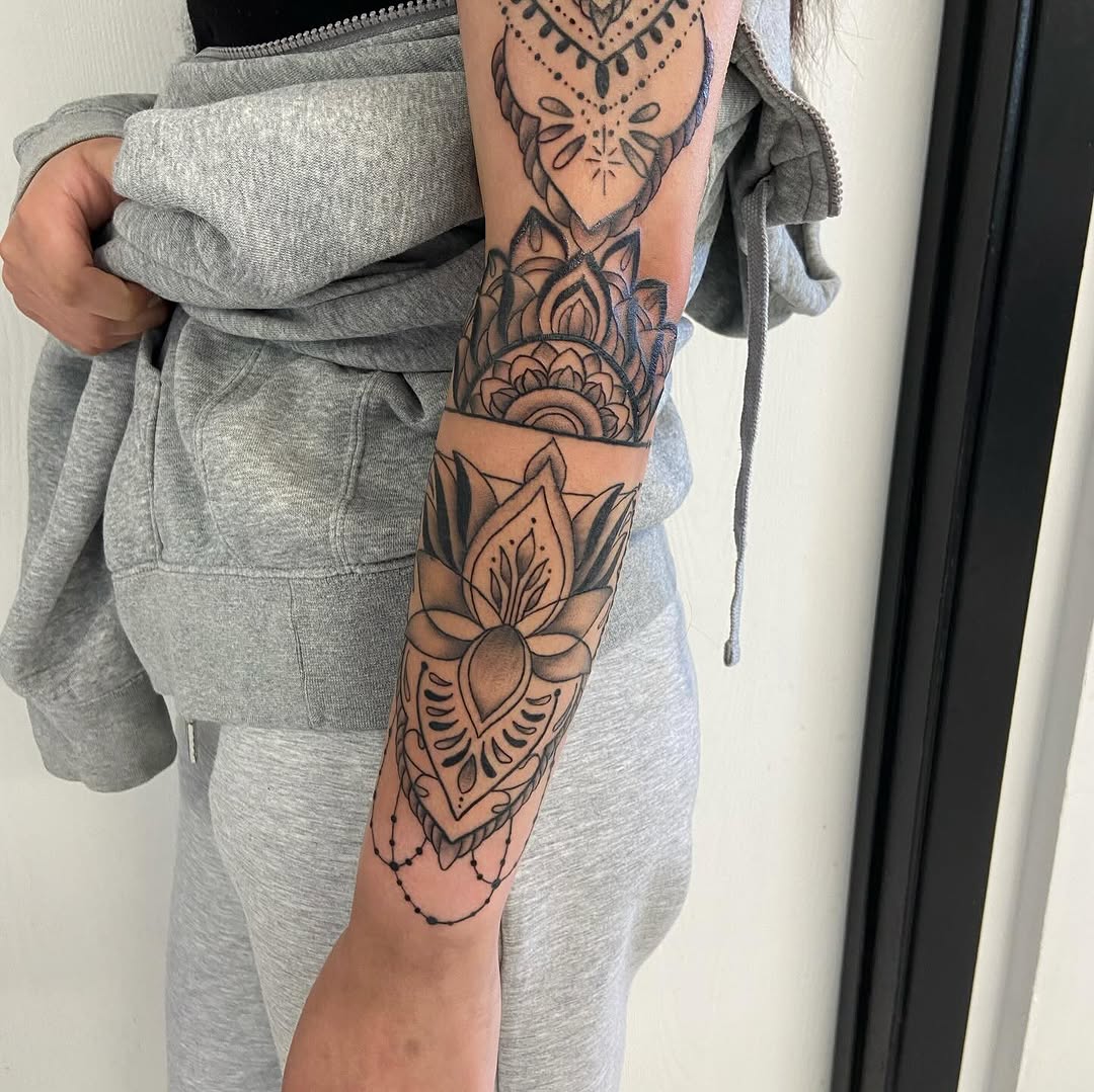 Mandala and lotus flower ornamental tattoo on the forearm by Sophia