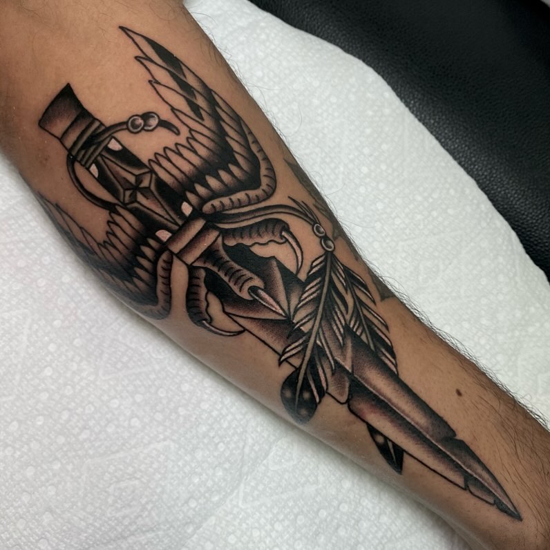 Bird and feather American traditional tattoo on the forearm by Justin R. Mitchell, Fort Worth, Texas