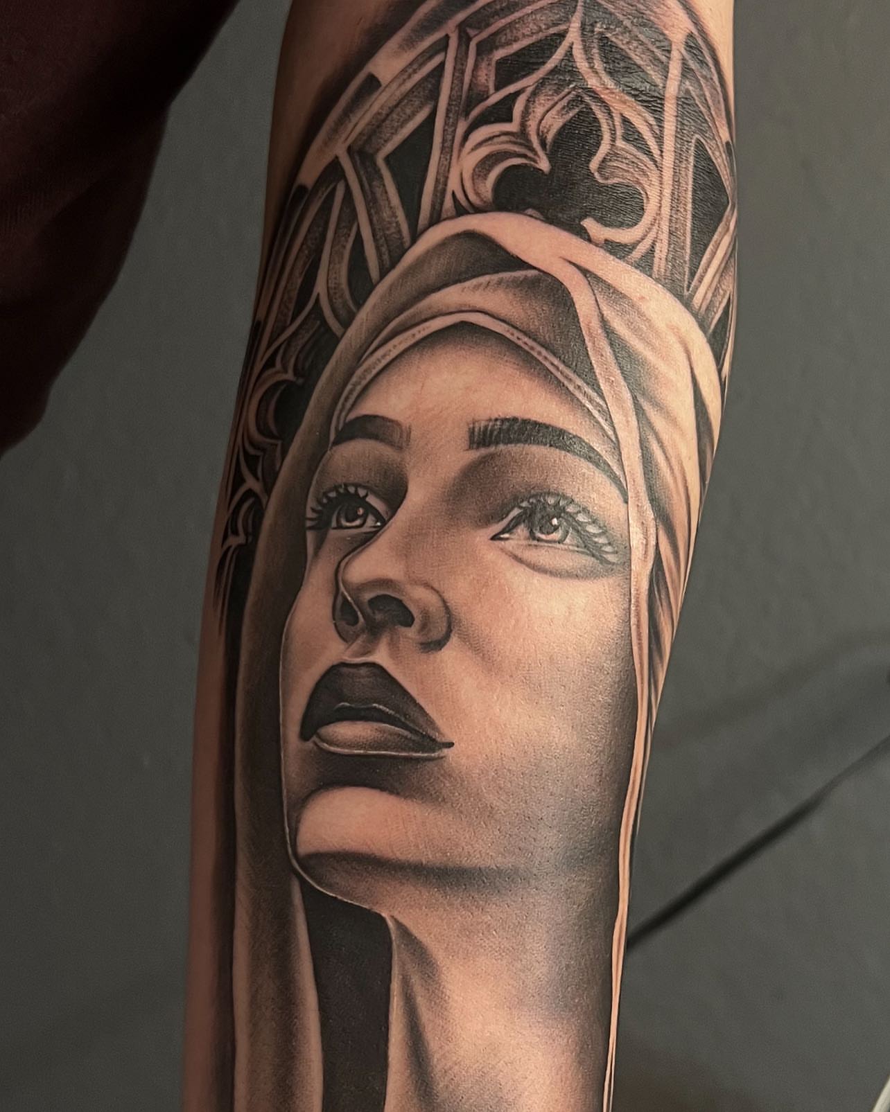Woman's face realism tattoo on the forearm by Hugo Ruiz-Esparza