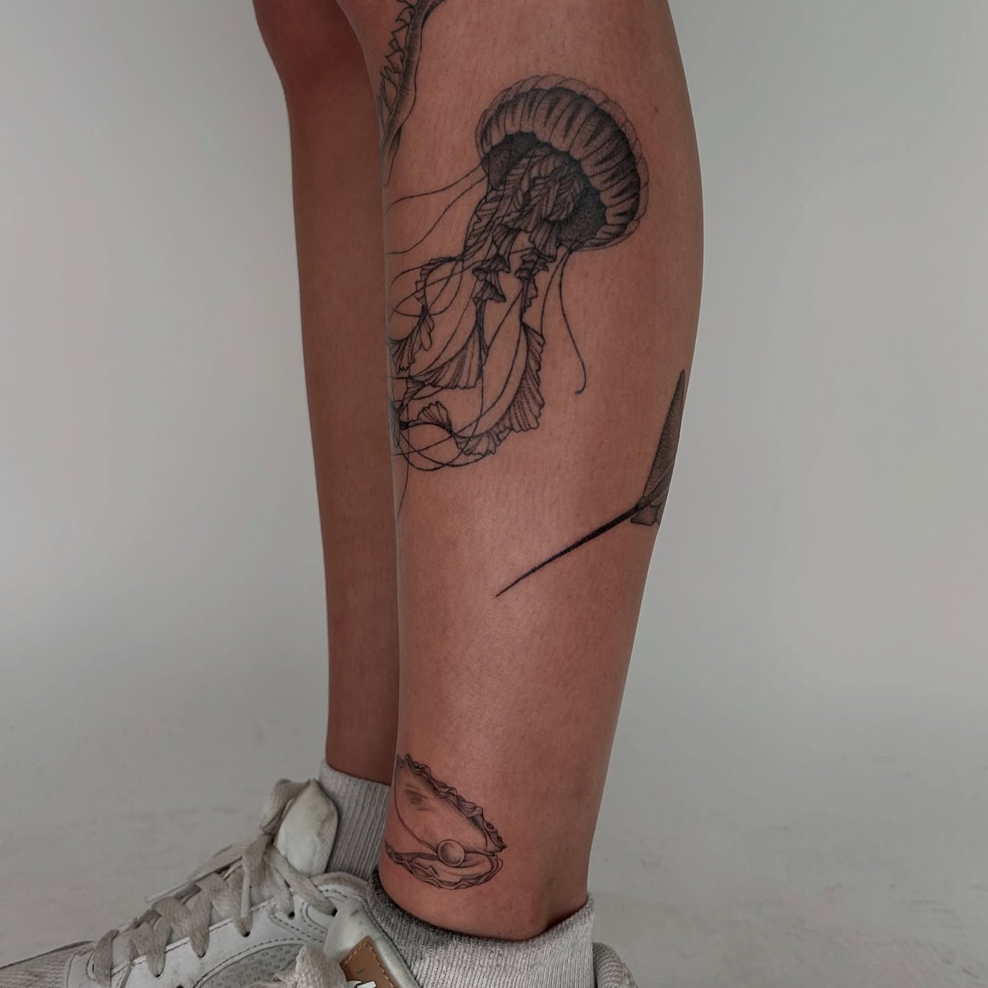 Jellyfish black and grey tattoo on the calf by Kennedy Ramey