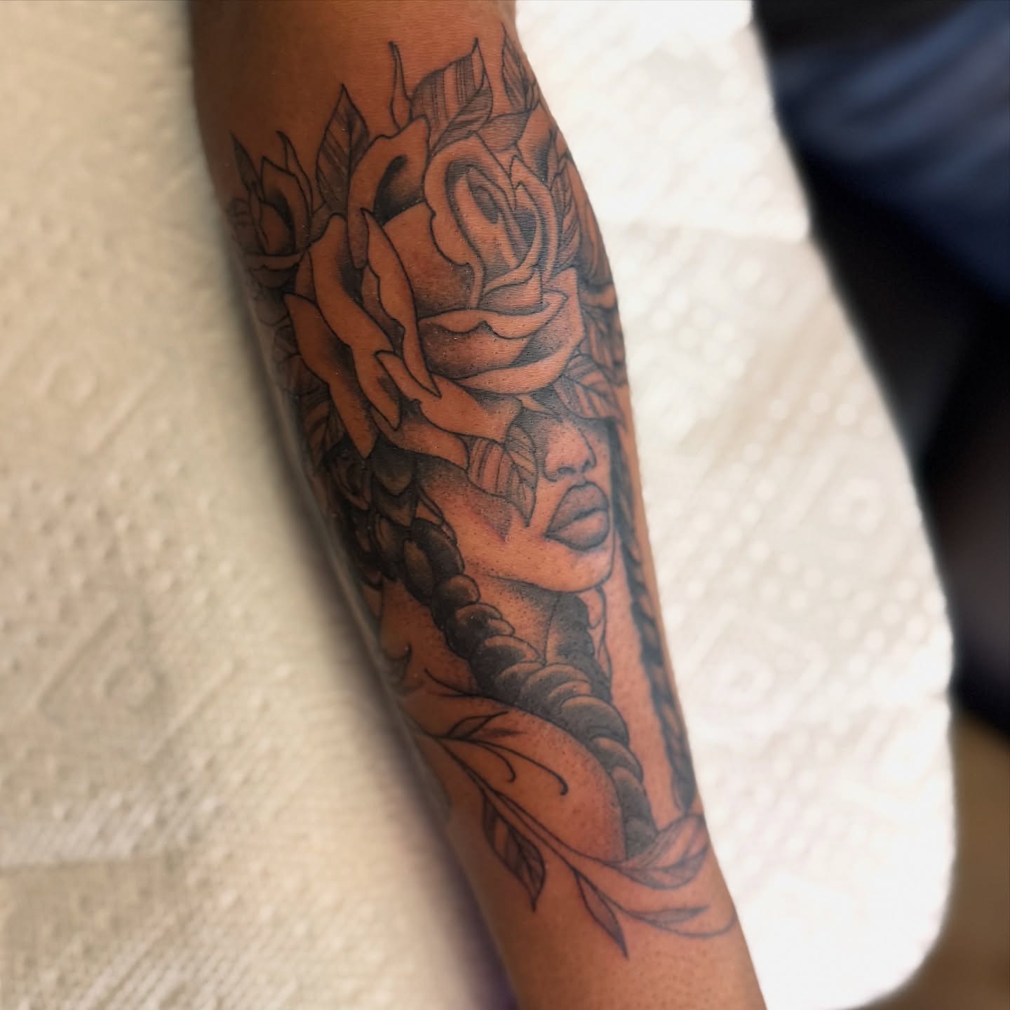 Woman with rose black and grey tattoo on the forearm by Scott Kulikowski