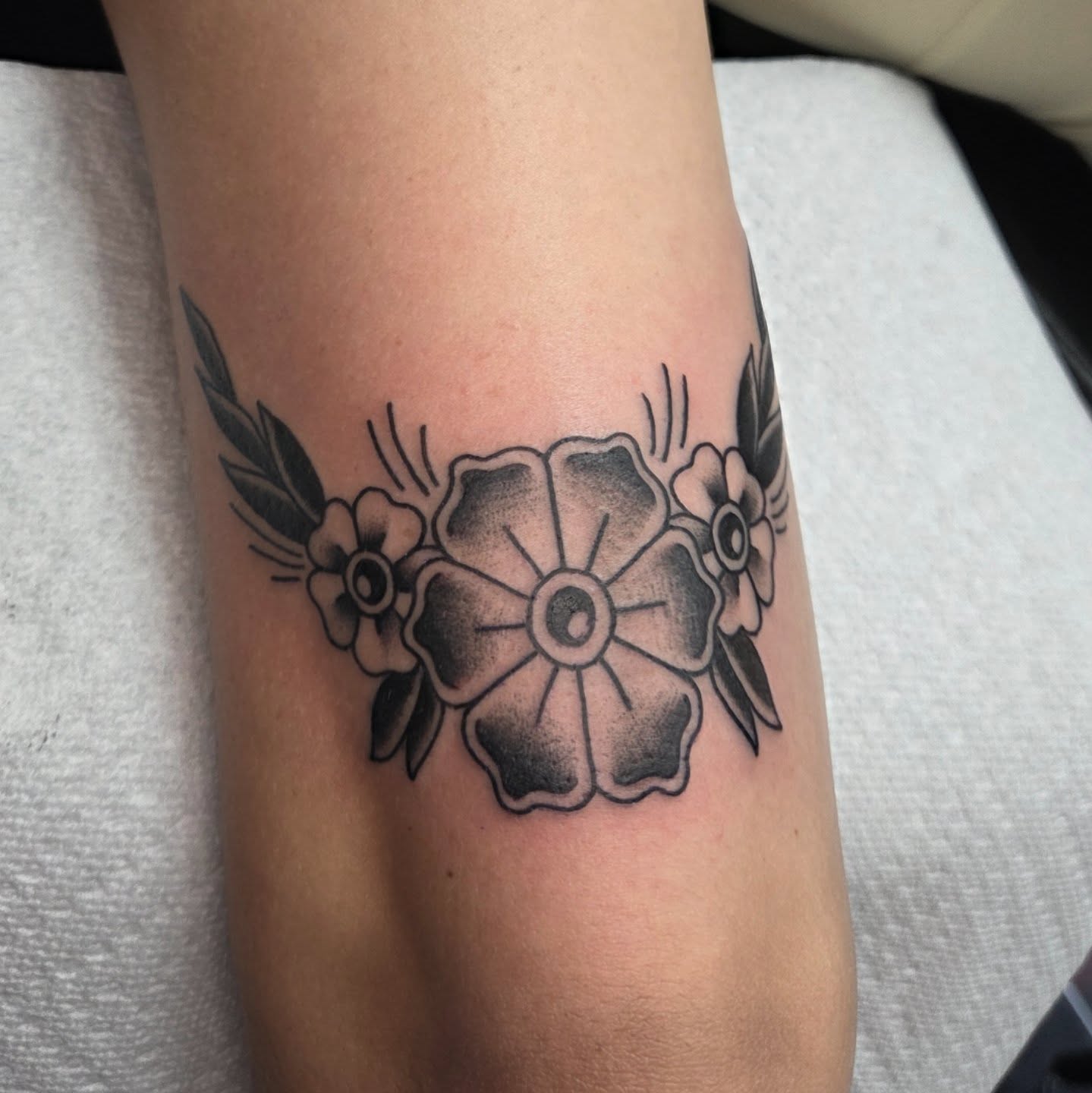 Flower American traditional tattoo on the forearm by CASEY JENSEN ✨ Fort Collins CO