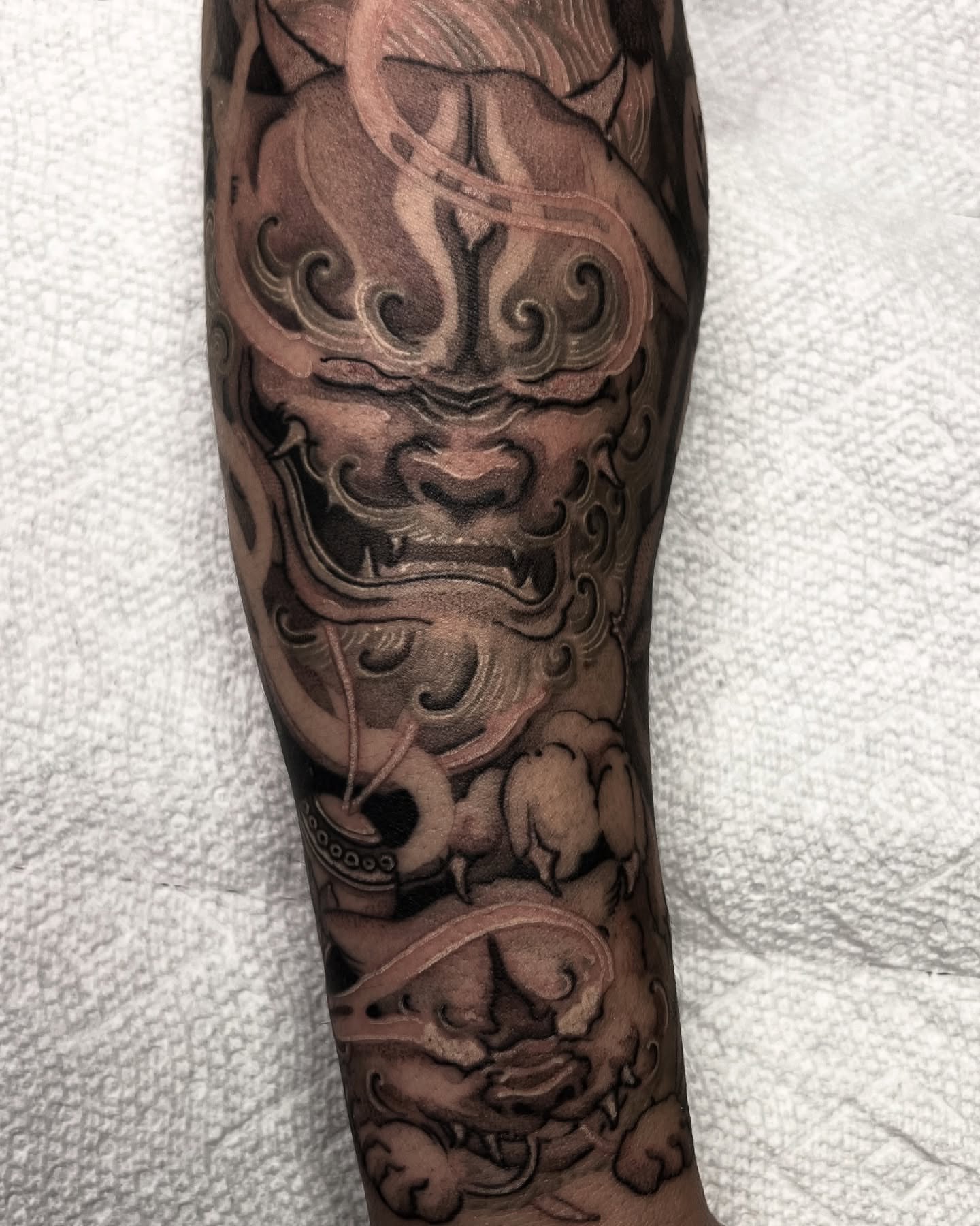 Lion black and grey tattoo on the forearm by Joshua Hung, Alhambra, California