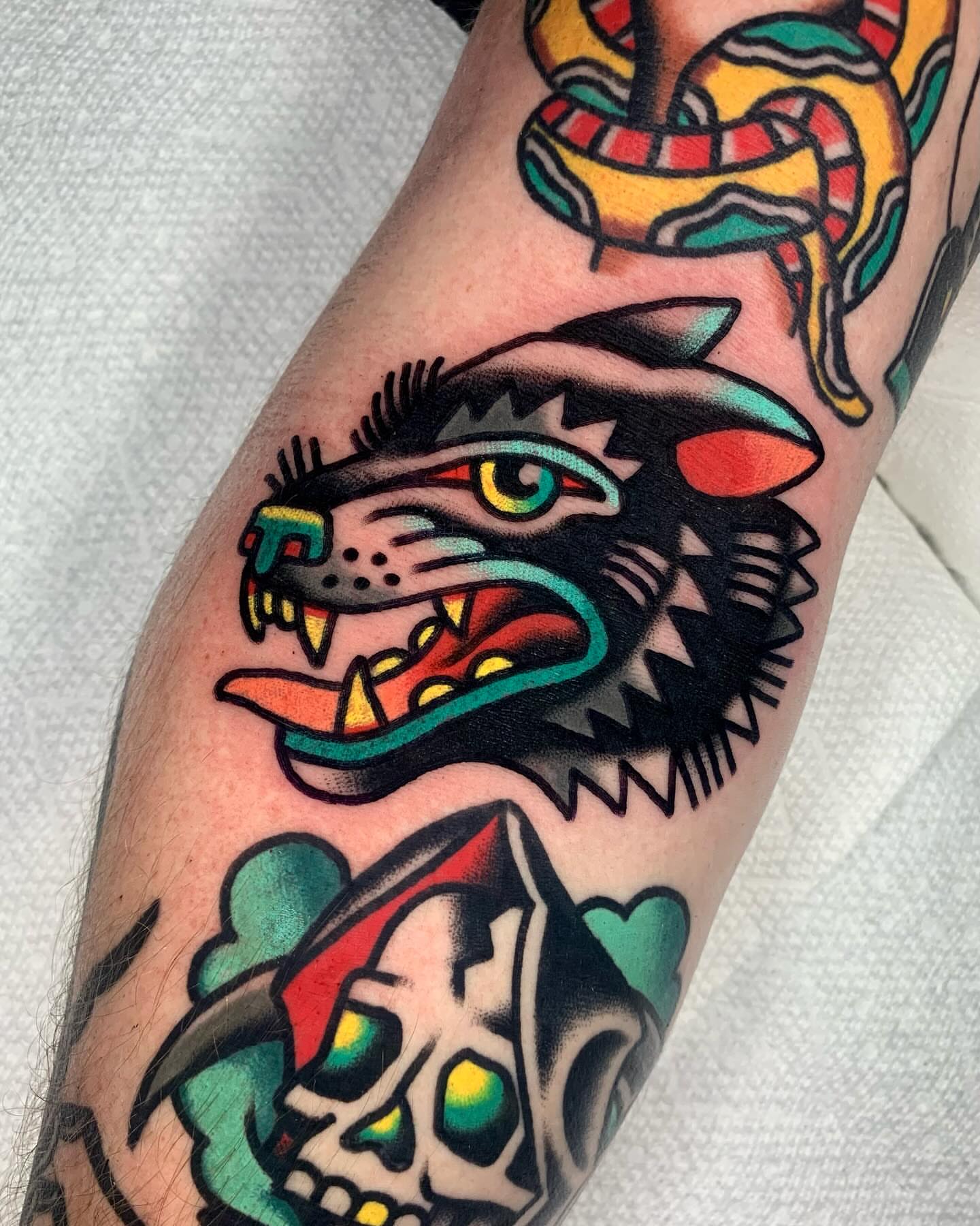 Wolf head American traditional tattoo on the forearm by Shawn VanKirk