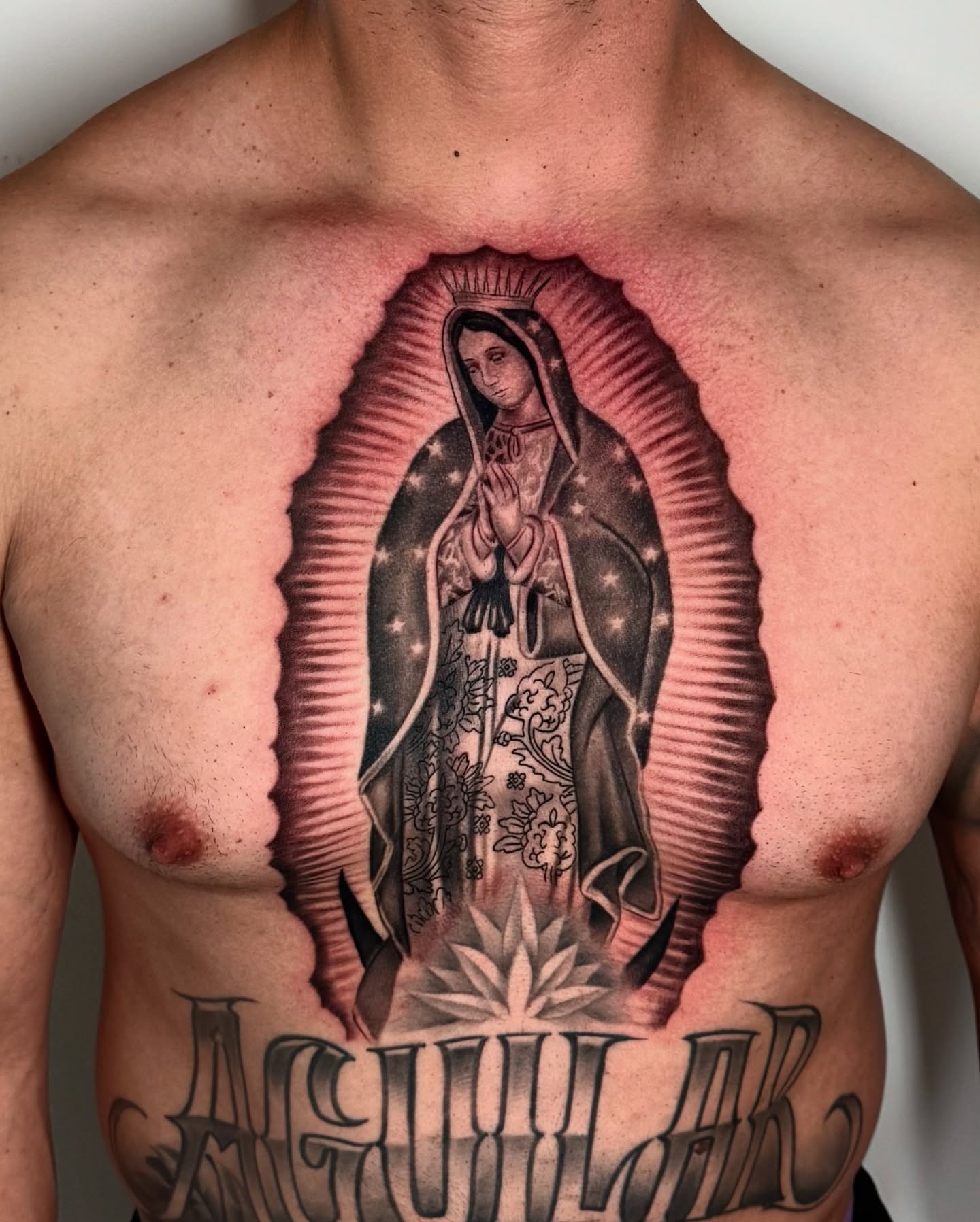Our Lady of Guadalupe American traditional tattoo on the chest by Luis Peña