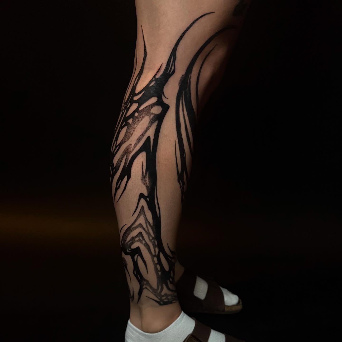 Abstract flame black and grey tattoo on the calf by Dylan Orbock, Berkeley, California