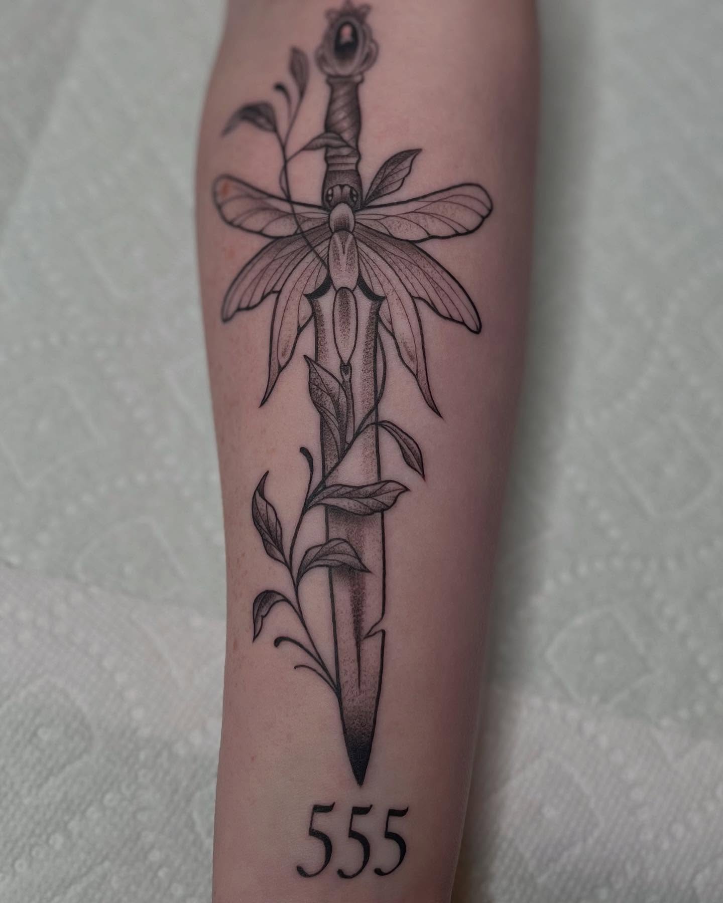 Sword and flower realism tattoo on the forearm by Lexi Ross