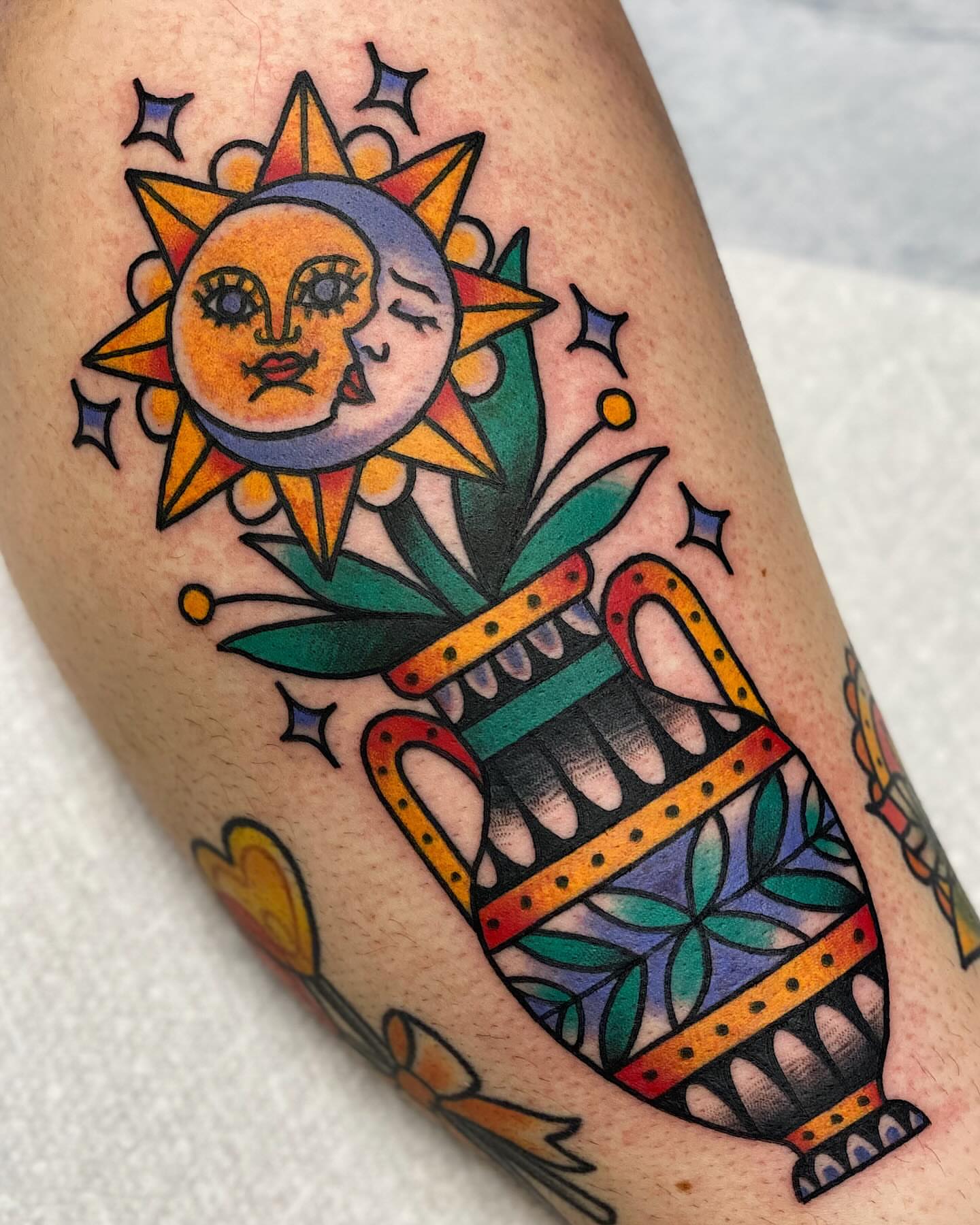 Sun and moon American traditional tattoo on the thigh by Dakota Amato