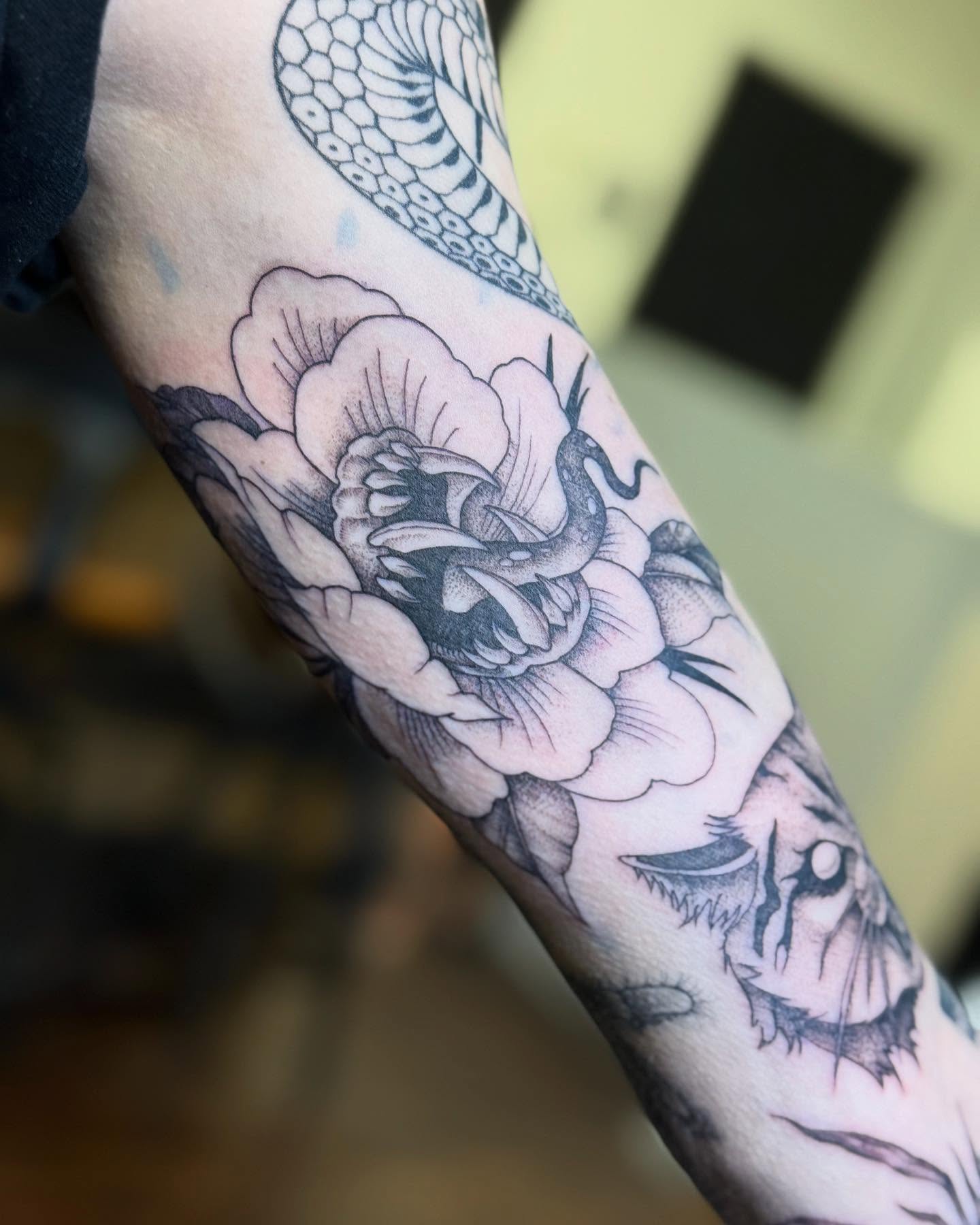 Peony and snake realism tattoo on the forearm by Katie Stacy