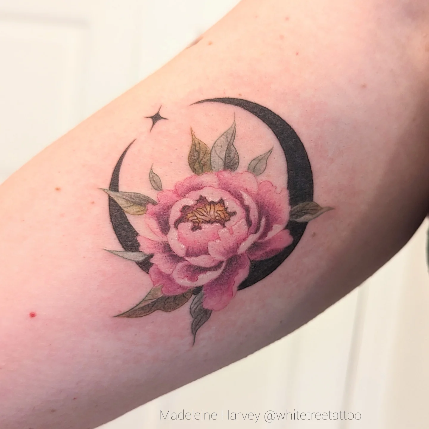 Peony and crescent moon realism tattoo on the forearm by Maddie