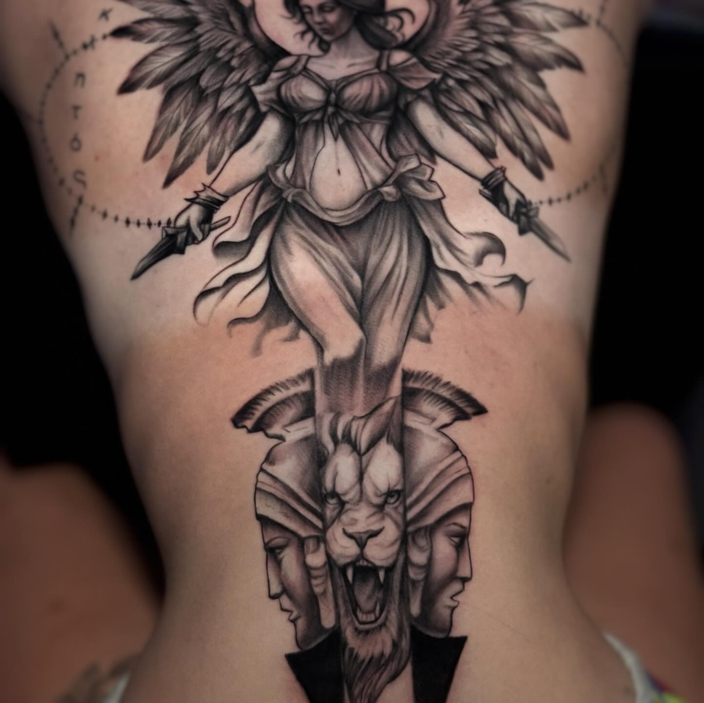 Angel and lion heads realism tattoo on the thigh by Juan Russo