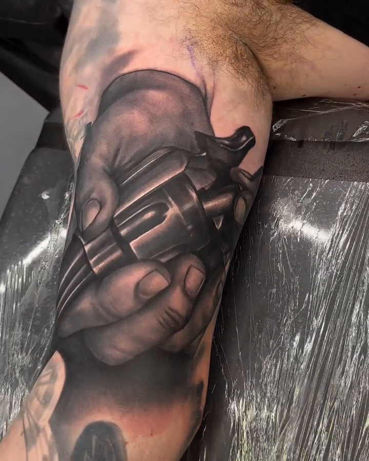 Revolver in hands realism tattoo by Dakota Case