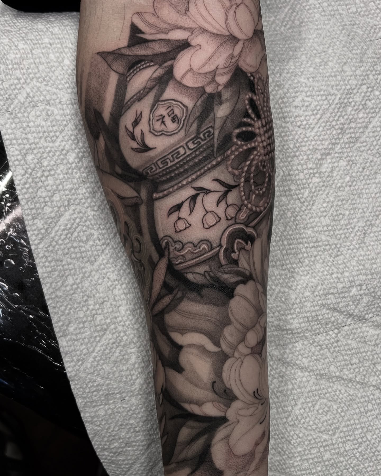 Peony vase realism tattoo on the forearm by Joshua Hung, Alhambra, California