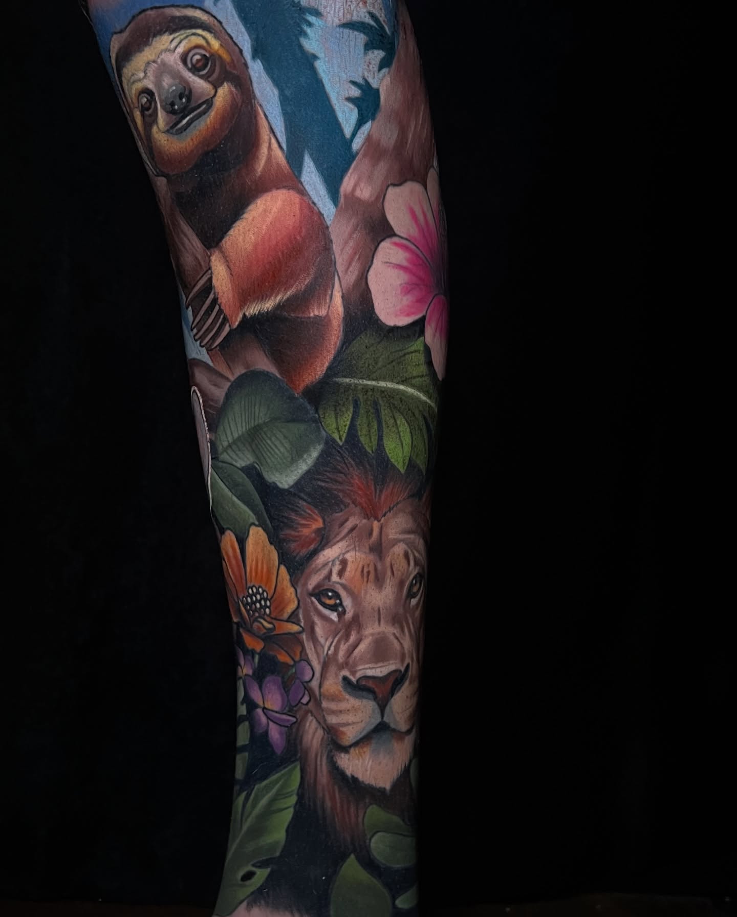 Lion and sloth realism tattoo on the forearm by Emily Walker