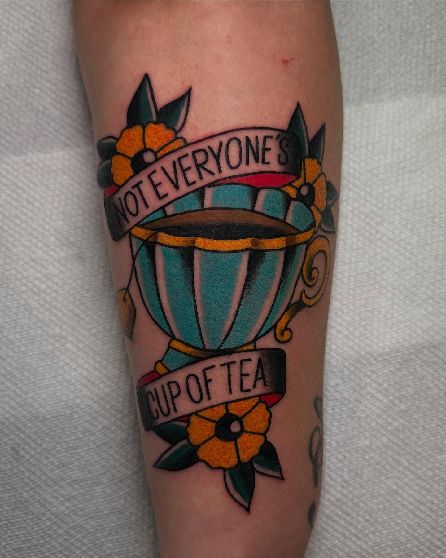 Cup of tea American traditional tattoo on the forearm by 𝕯𝖗𝖊𝖜 𝕲𝖎𝖑𝖊𝖘 𝕵𝖆𝖙𝖙𝖔𝖔, Addison, Texas