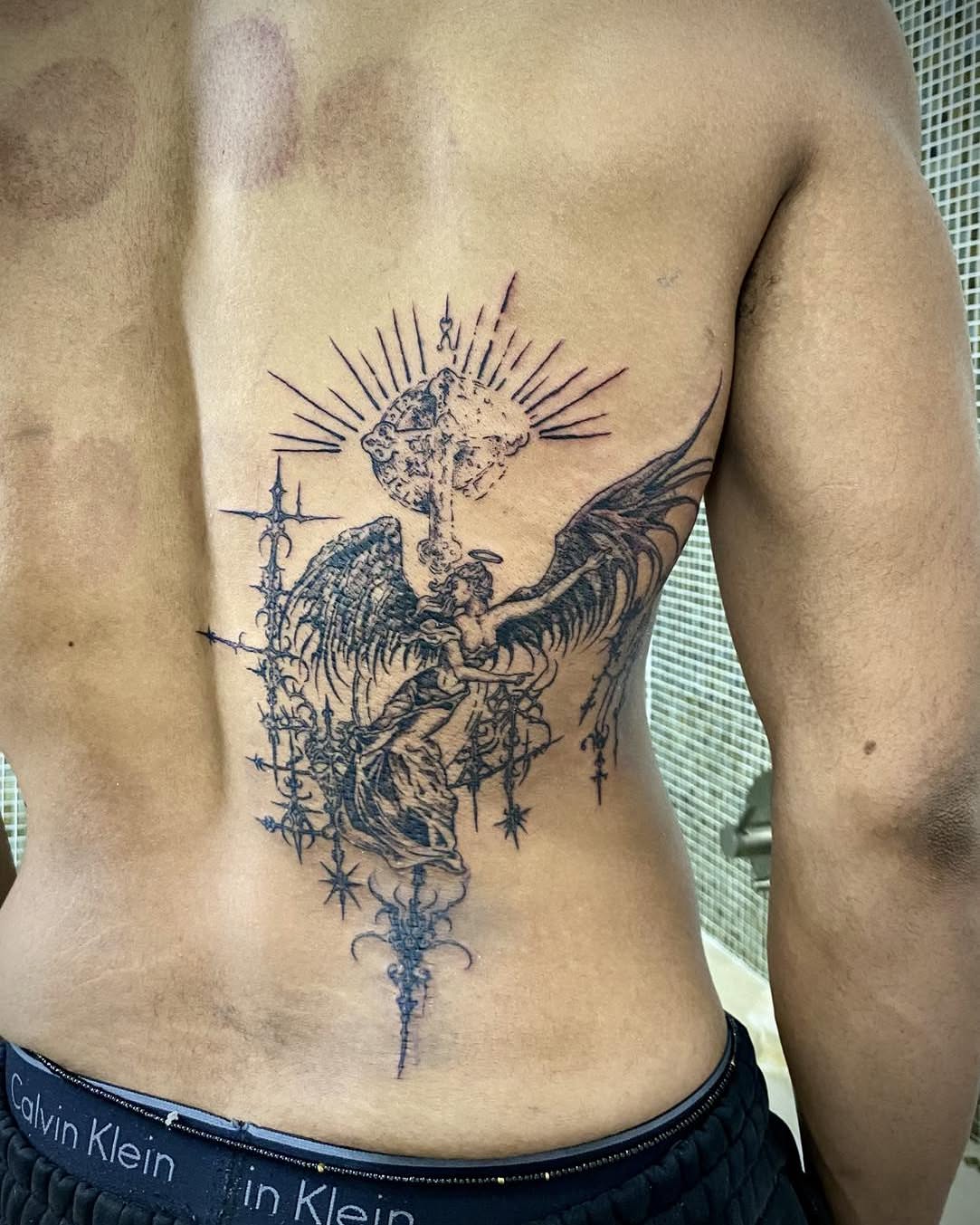 Angel and cross black and grey tattoo on the ribs by Quin Walker