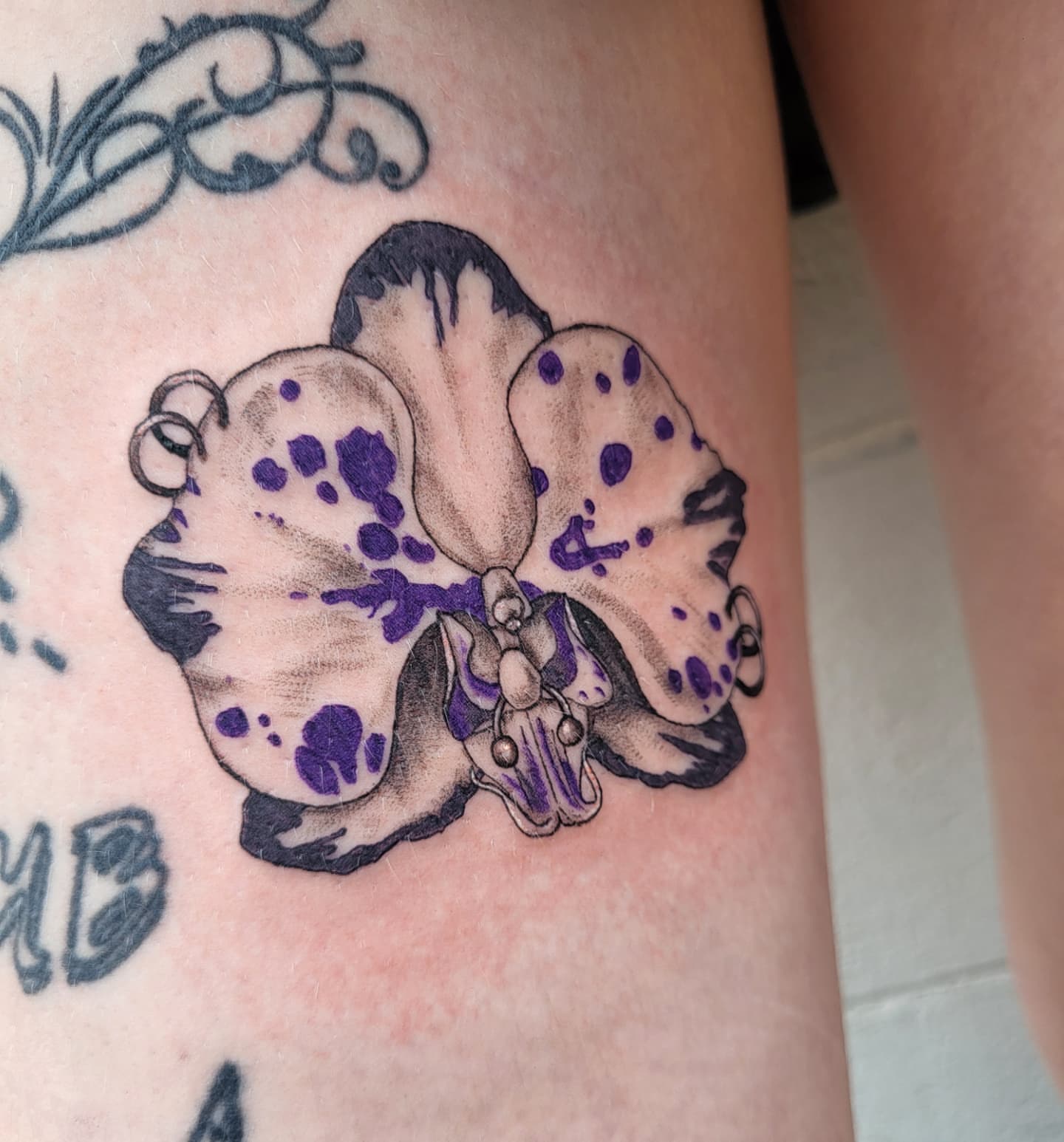 Orchid dotwork tattoo on the thigh by Jenna 🖤 Tattoos Denton TX