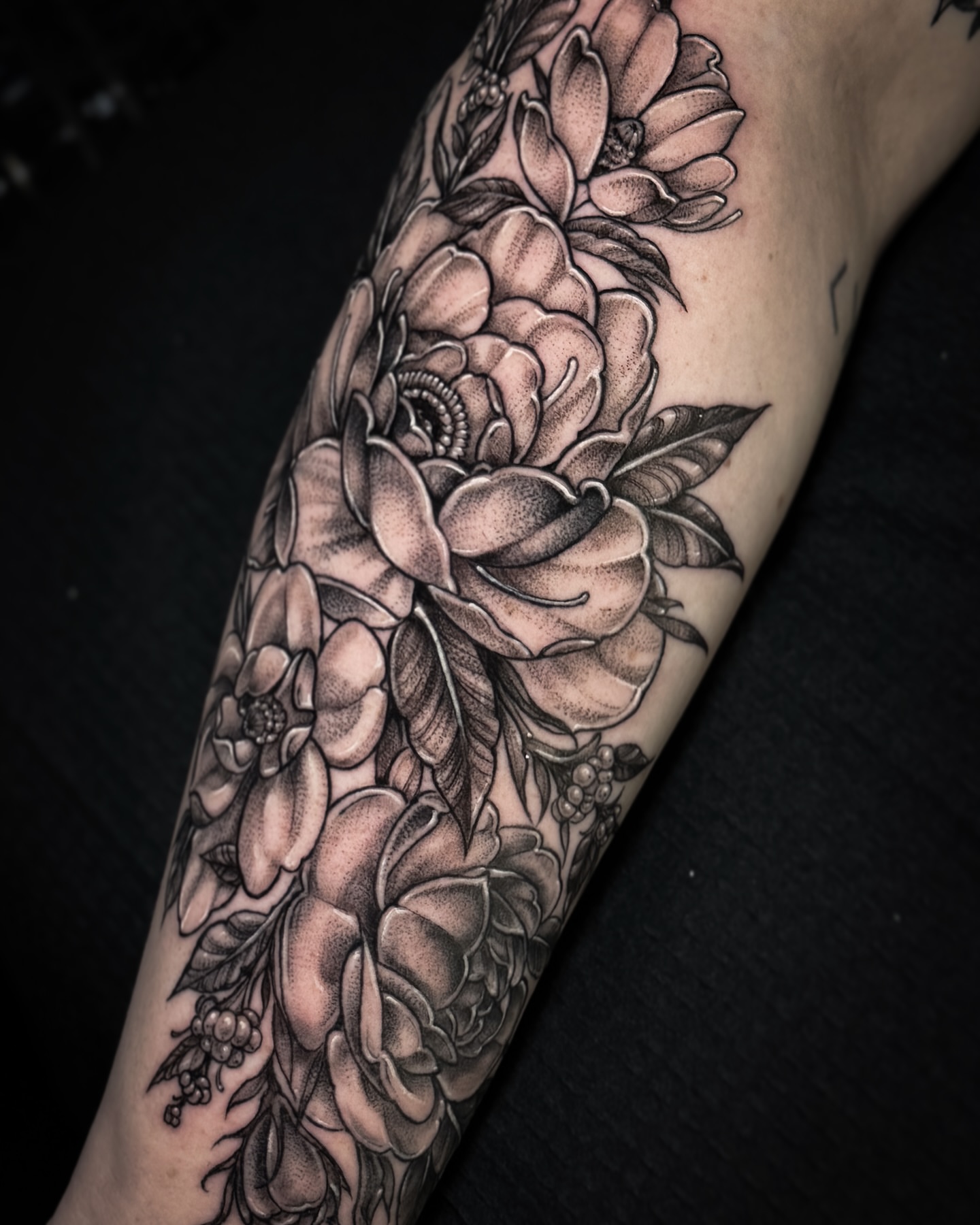 Floral bouquet black and grey tattoo on the forearm by Cristen Aro