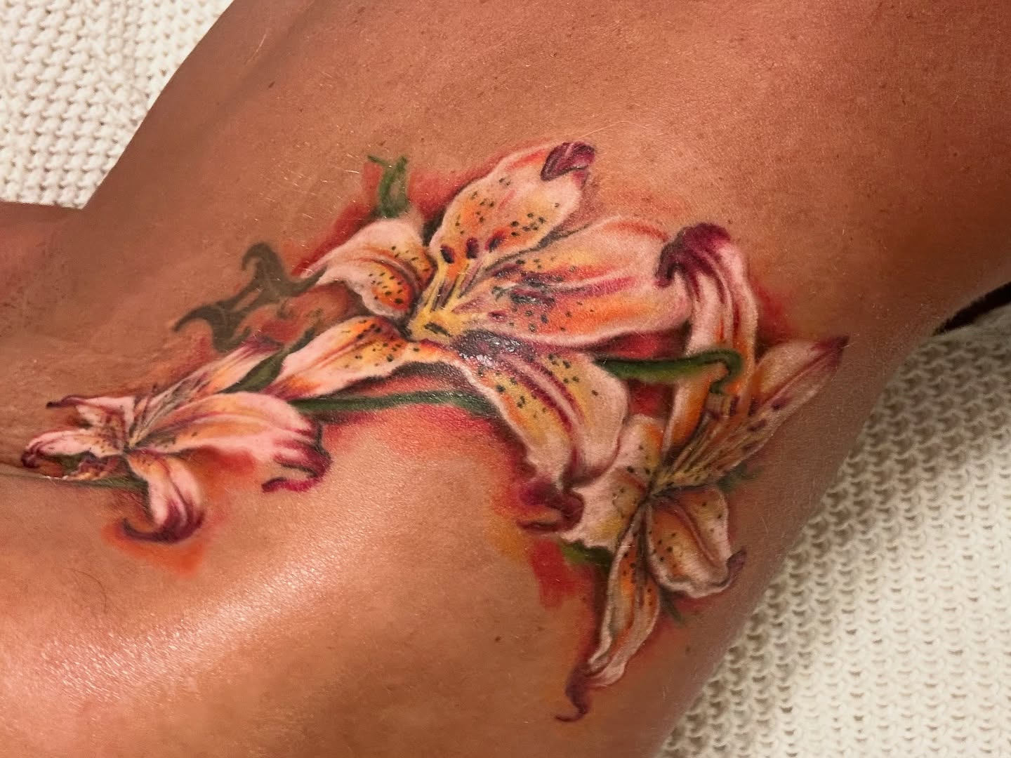 Lilies realism tattoo on the forearm by Chris Allen Taylor