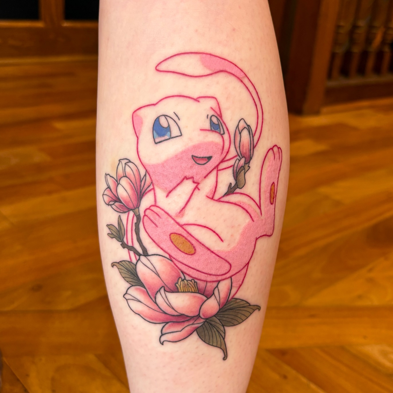 Mewtwo with flowers anime tattoo on the forearm by Alicia