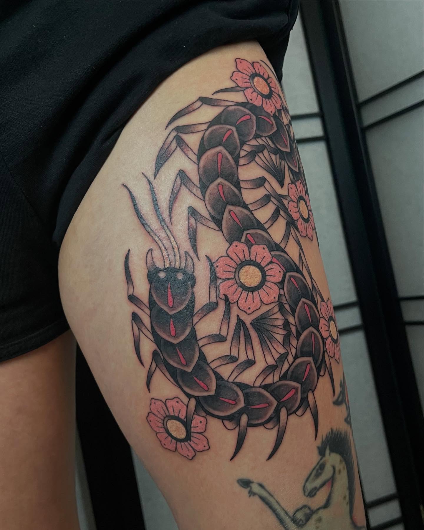Scorpion and flowers American traditional tattoo on the thigh by Seattle Tattoo Artist, Bonney Lake, Washington