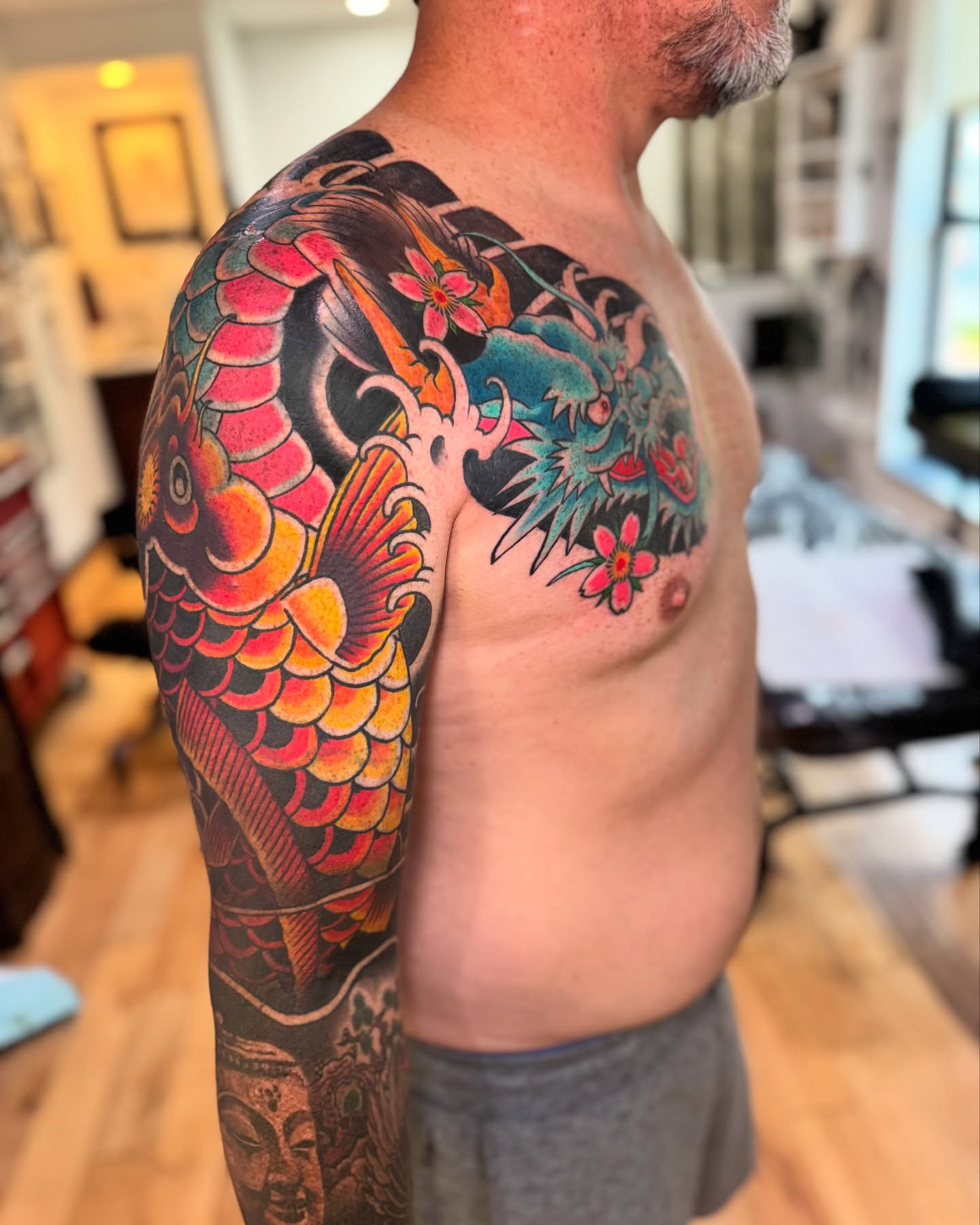 Koi fish and flowers japanese irezumi tattoo on the shoulder by David Gray